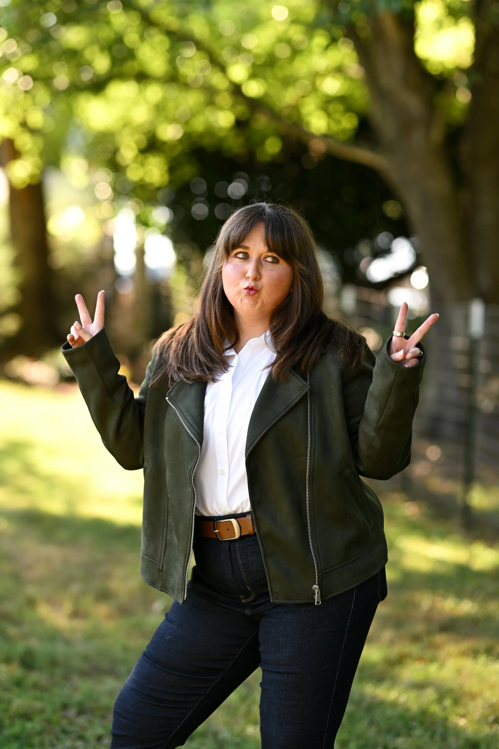 Jordan Peterson, LCMHCA, playfully flashing peace signs outdoors