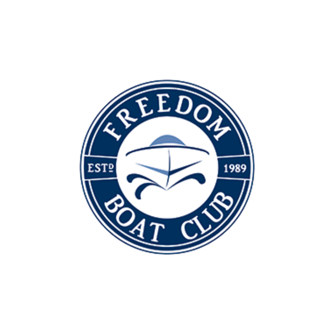 Circular logo for Freedom Boat Club featuring a stylized boat face, with the text "FREEDOM BOAT CLUB" around the rim and "EST 1989" on two sides.