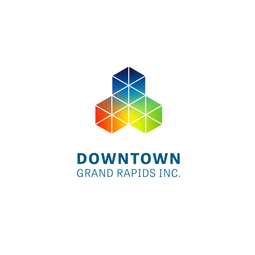 Colorful geometric logo for Downtown Grand Rapids Inc., featuring a 3D cube made of smaller triangular sections in shades of blue, green, yellow, and red, with the text "DOWNTOWN GRAND RAPIDS INC." underneath.