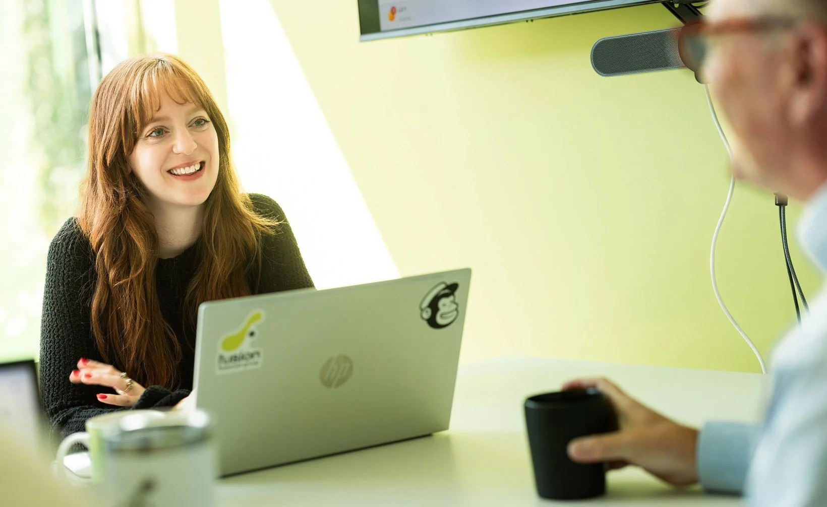Woman smiling as she delivers monthly financial assessment to client