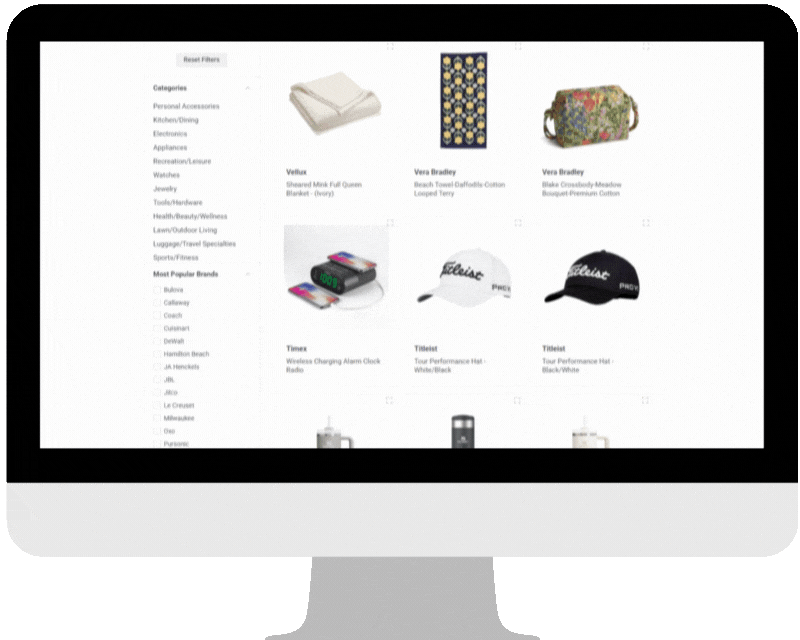 Online company store website displayed on a computer screen showing various products, including a blanket, a floral bag, a digital alarm clock, and black and white baseball caps, with a sidebar of product categories.