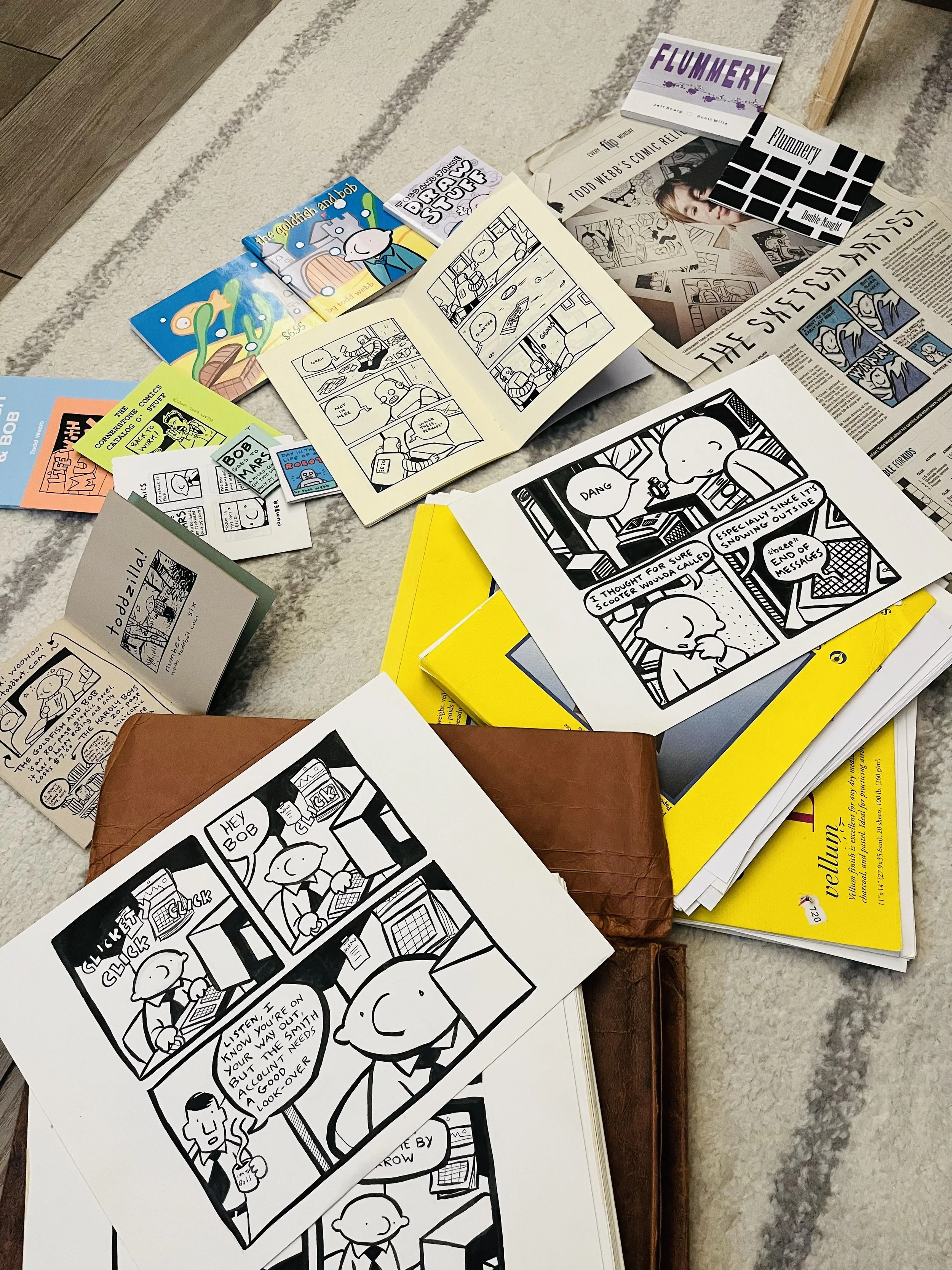 a pile of Todd Webb comics ephemera - mini-comics, original artwork, newspapers