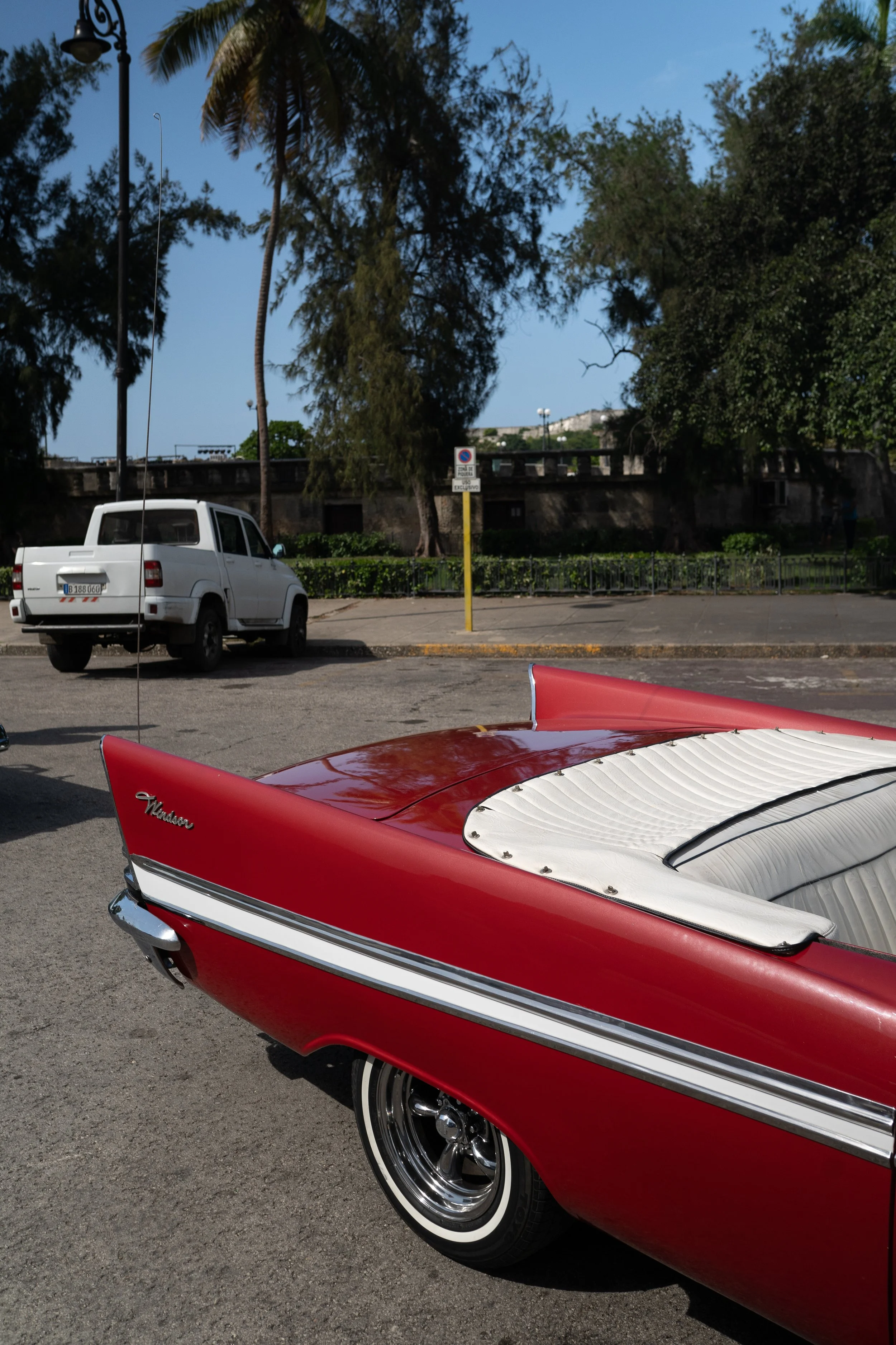 Close-up of a vintage red and white car with a