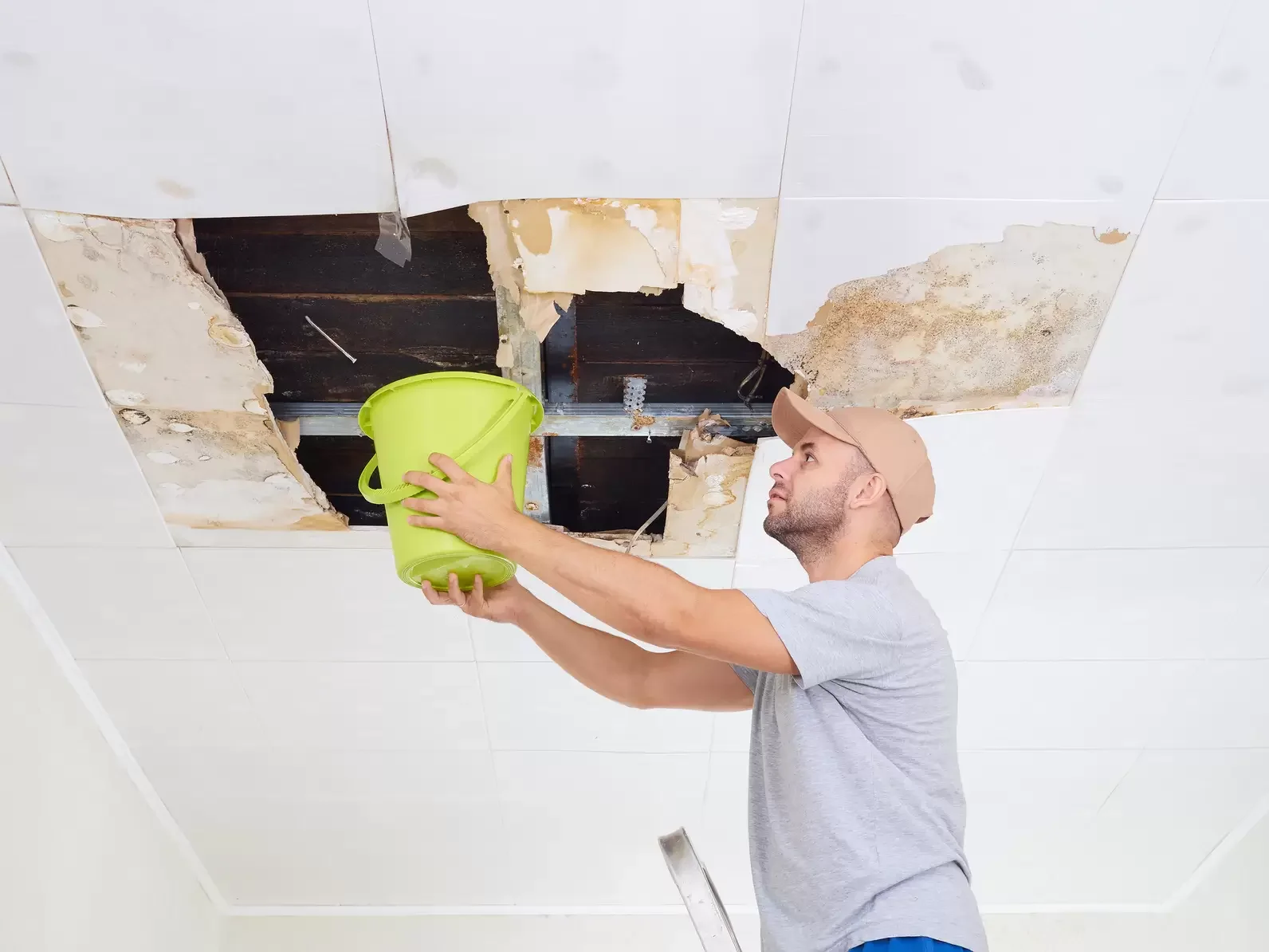 Interior photo showing a damaged ceiling with water dripping from a roof leak; Superior Restoration & Remodeling team provides emergency cleanup and restoration services across Manhattan, Brooklyn, Queens, Nassau, Suffolk, and Westchester.