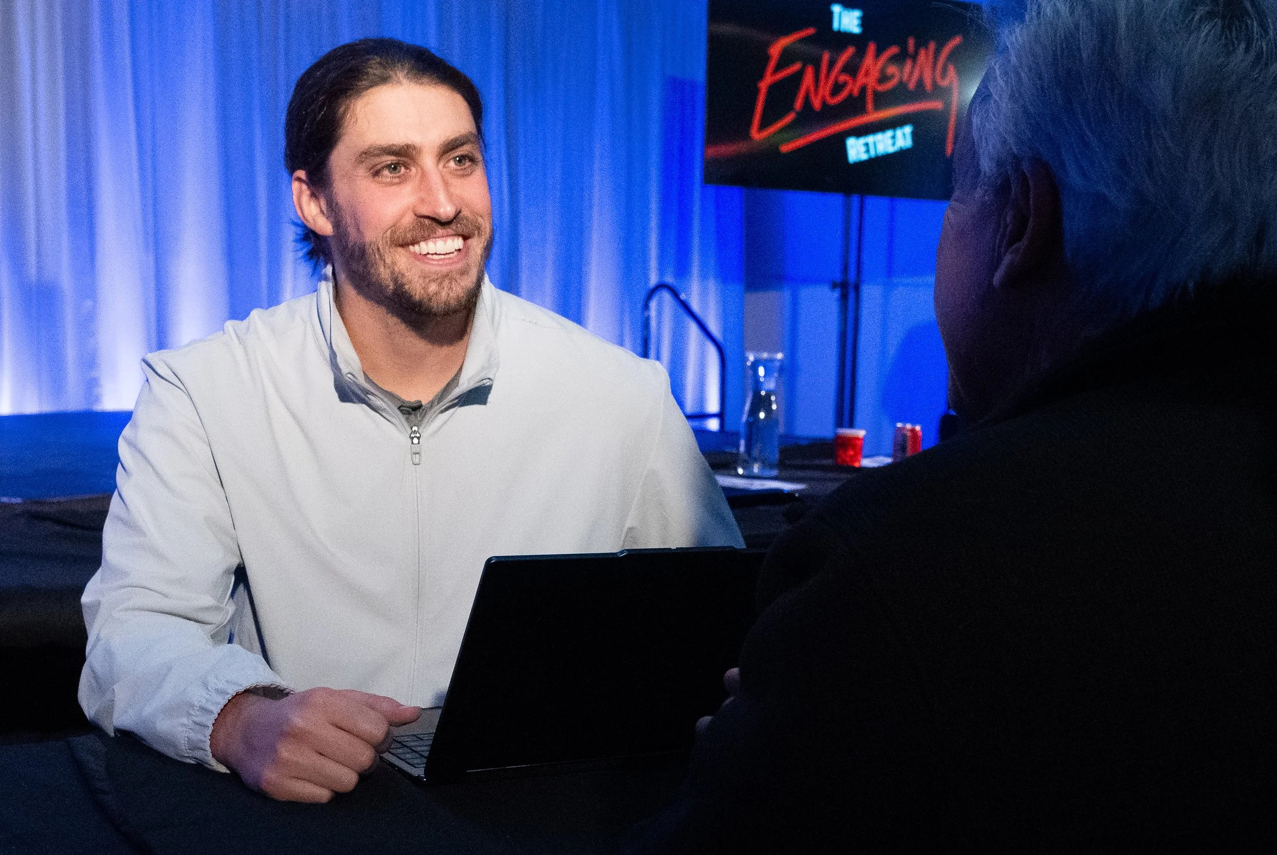Photo of Ethan sitting across from a one on one coaching client.