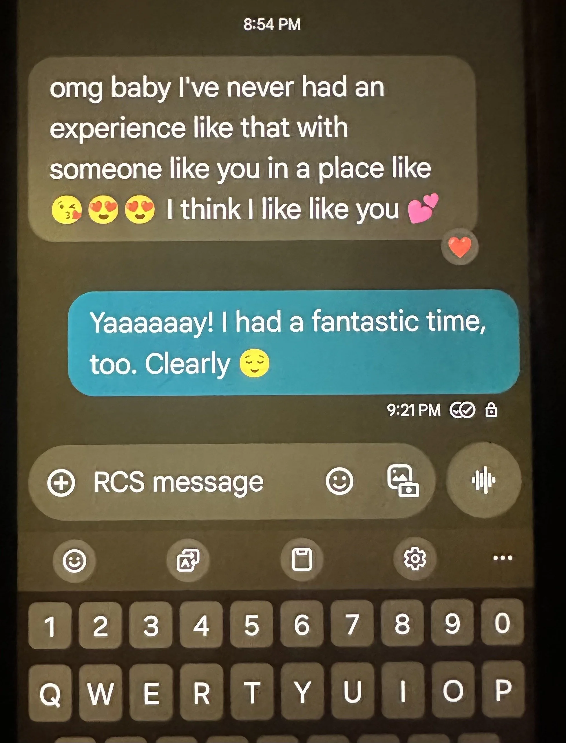 A smartphone screen displaying a WhatsApp conversation with messages expressing love and happiness between two people, including emojis like hearts, kisses, and smiling faces.