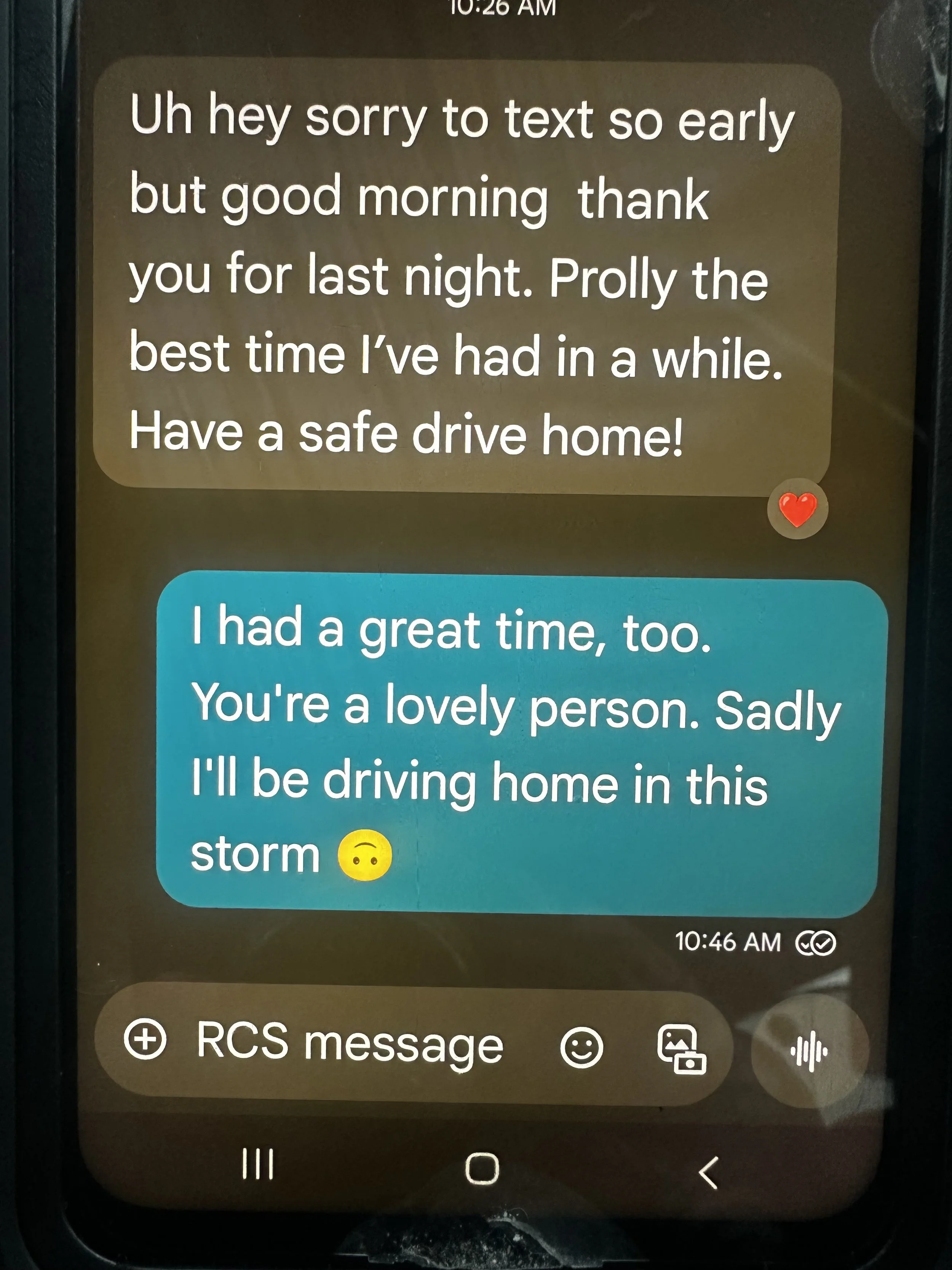 A screenshot of a text message conversation on a smartphone. The first message, in a brown bubble, apologizes for texting early and thanks someone for last night, wishing them a safe drive home. The second message, in a blue bubble, responds that the