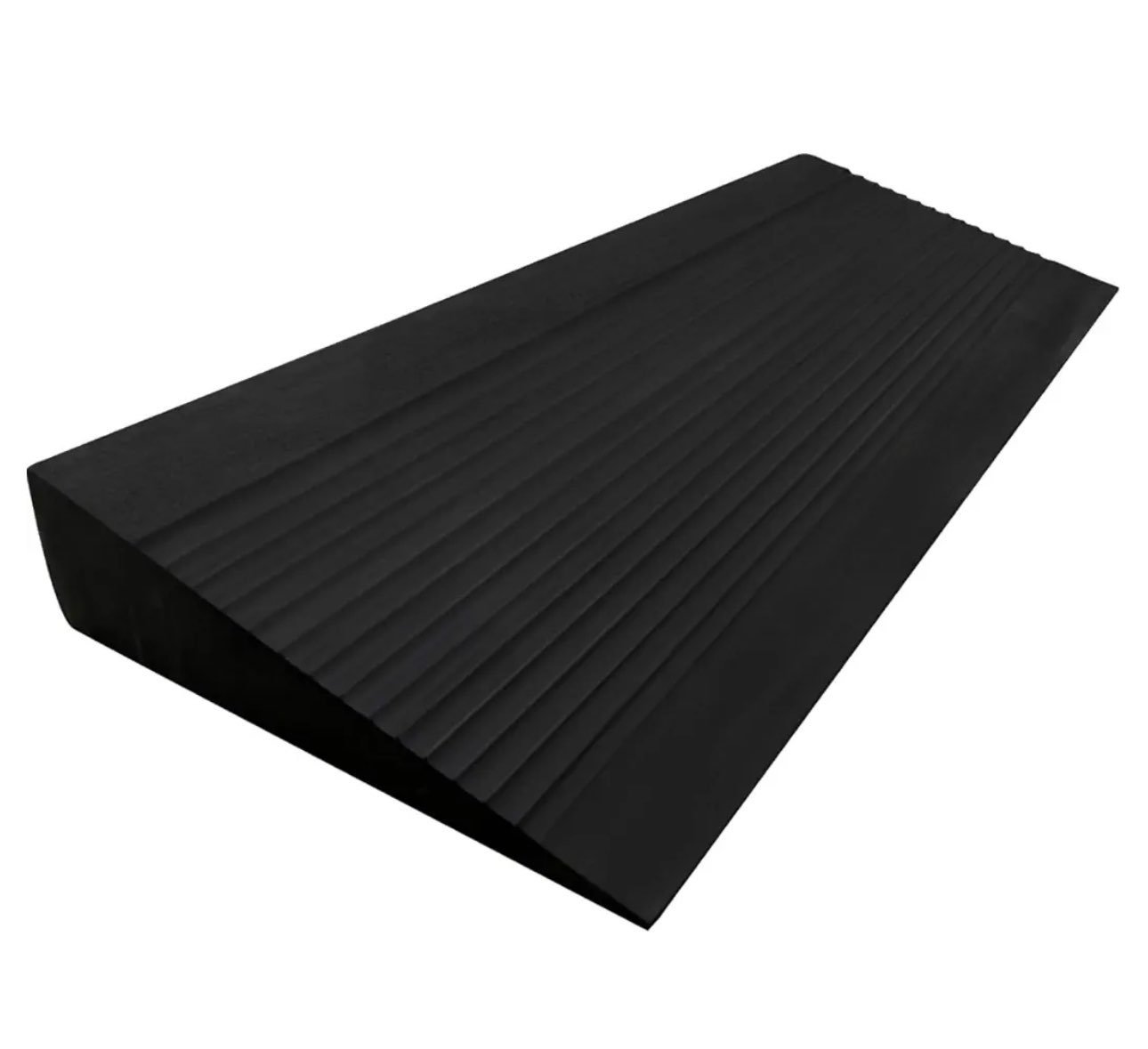 Black rubber squat wedge with parallel ridges on a white background.