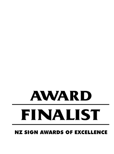 Black and white award badge for NZ Sign Awards of Excellence 2025, with a stylized quill pen at the top.