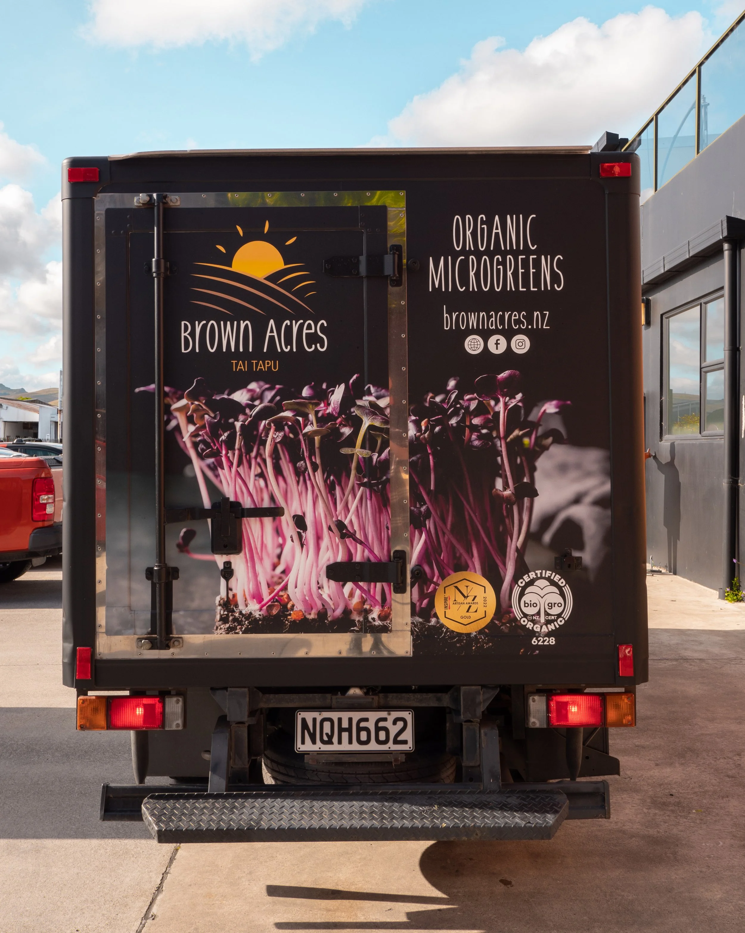 Food truck with branding for Brown Acres, featuring an image of purple microgreens, and the text 'Organic Microgreens' and 'brownacres.nz'.