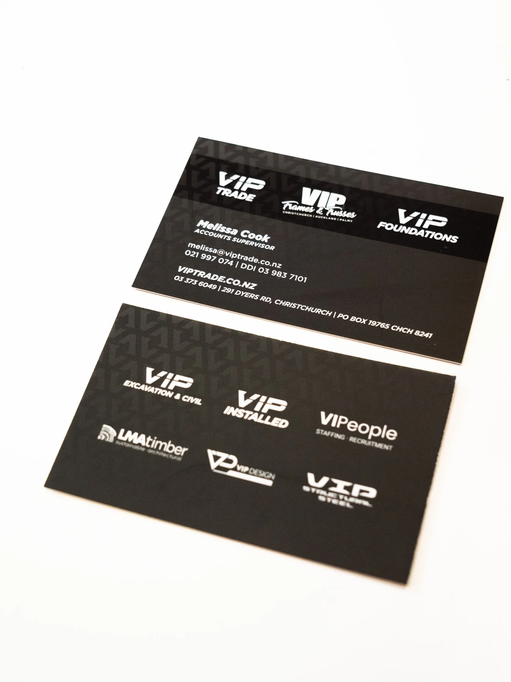 Business cards for VIP Trade and VIP Foundations, featuring contact details for Melissa Cook and various company logos in black and white.