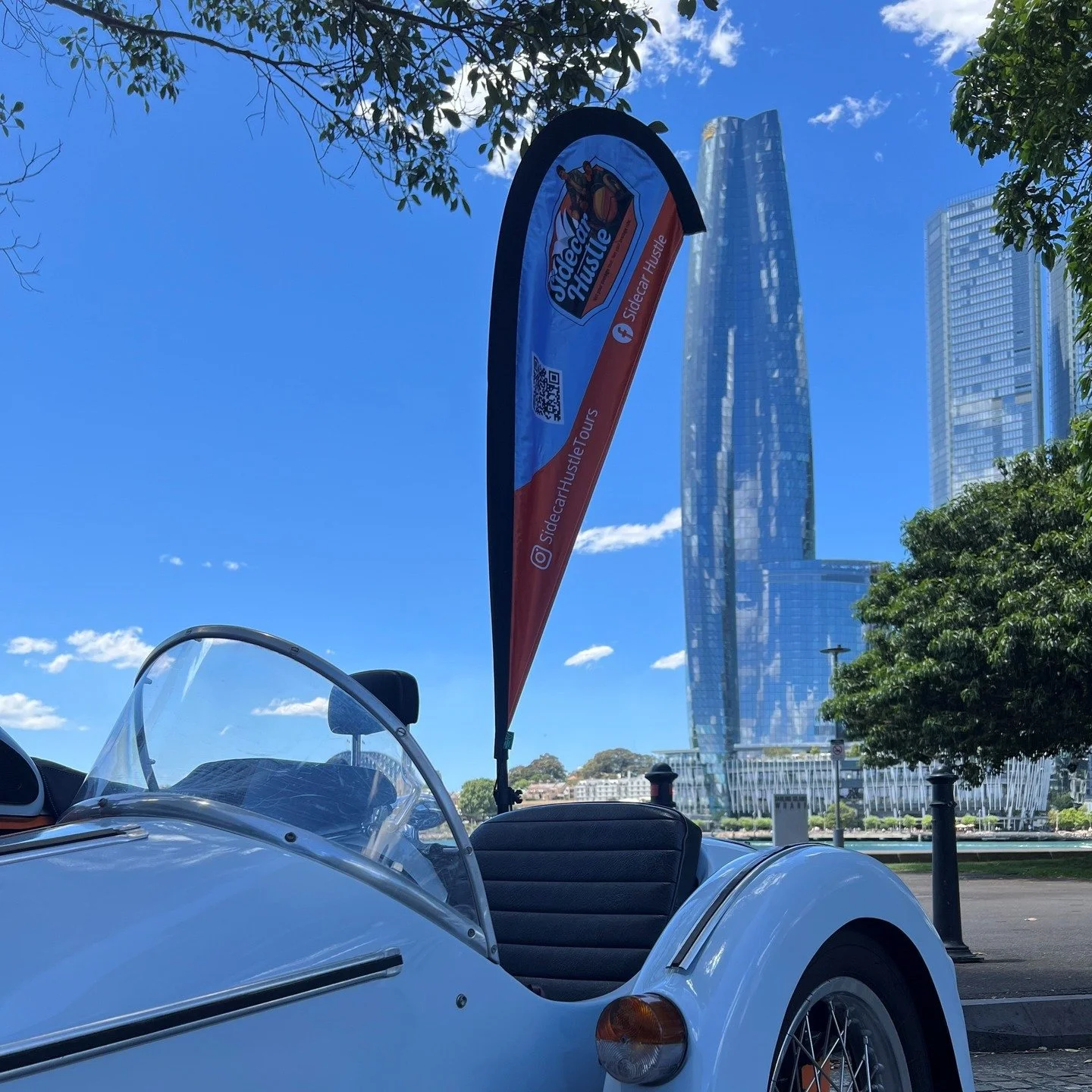 Blue sky, blue vibes, blue sidecar &mdash; Sydney really nailed the colour coordination today. 💙🏍️
Crown Tower almost disappears as it reflects the best of the heavens and the harbour. When the city serves a backdrop this good, all we have to do is