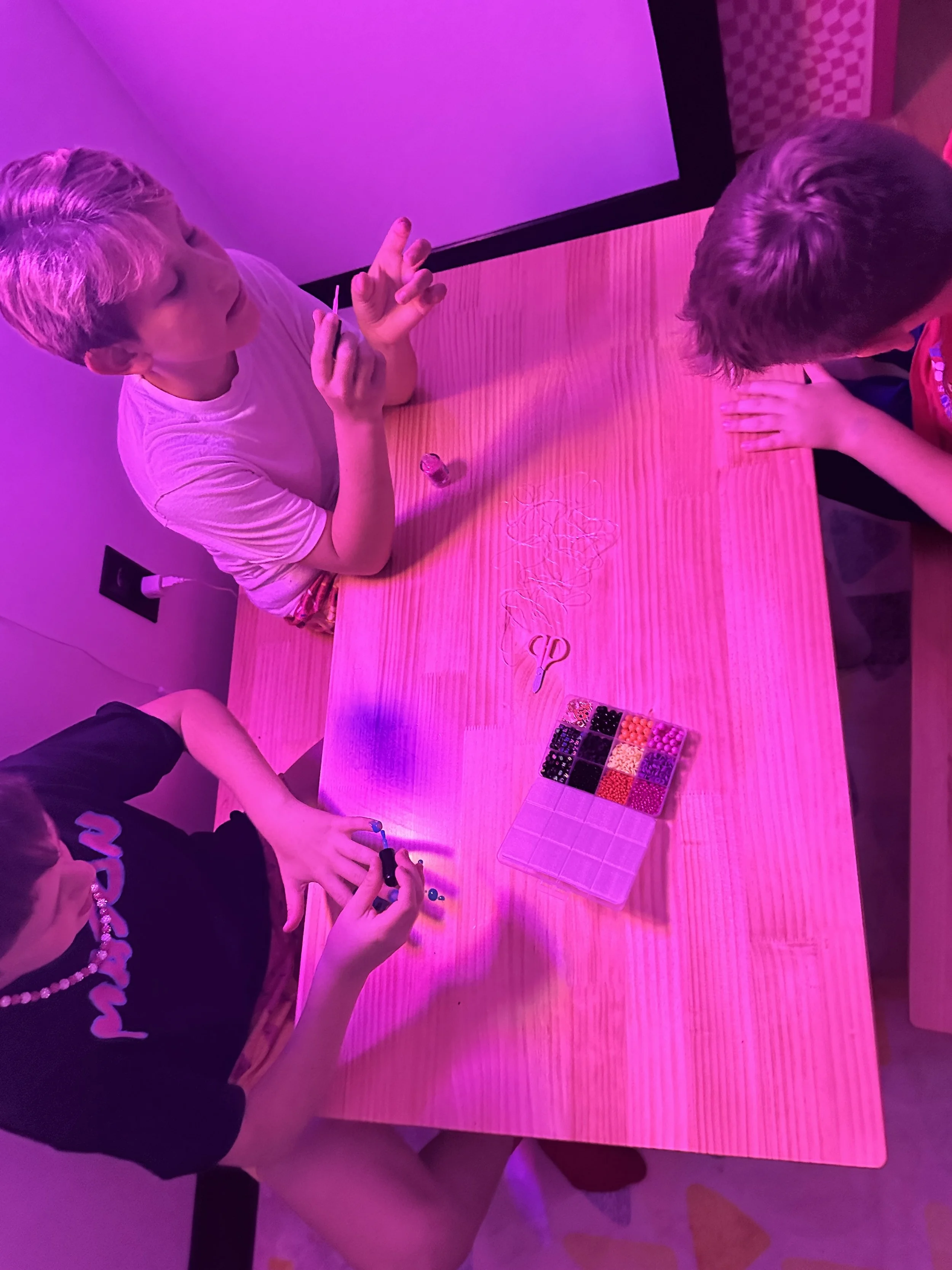A group of kids painting Halloween designs together during The Clubhouse Tween Bash — creative expression and teamwork in a festive after-school environment.