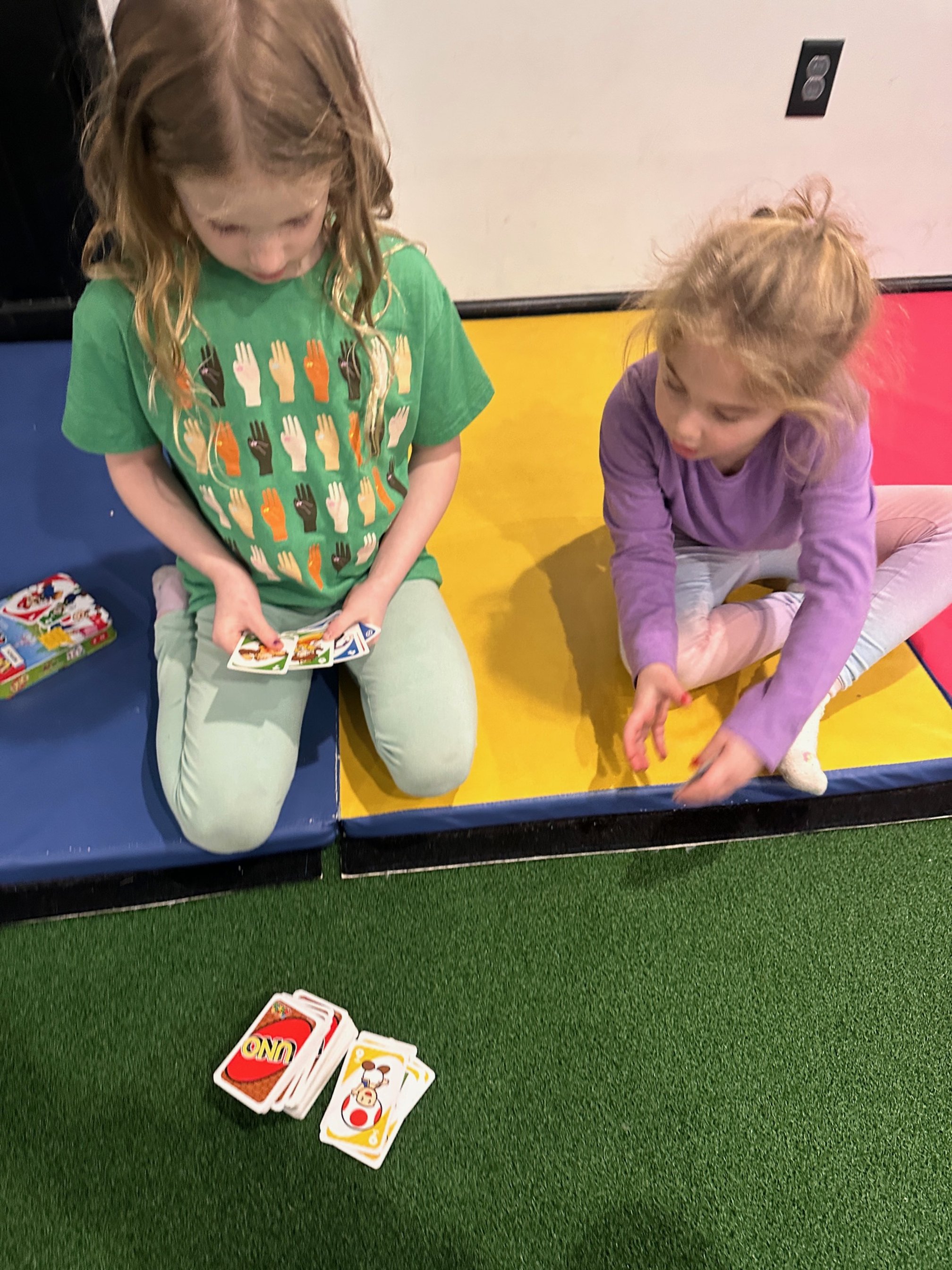 Kids card games on indoor turf at The Clubhouse play space Phoenixville PA near Audubon and Oaks