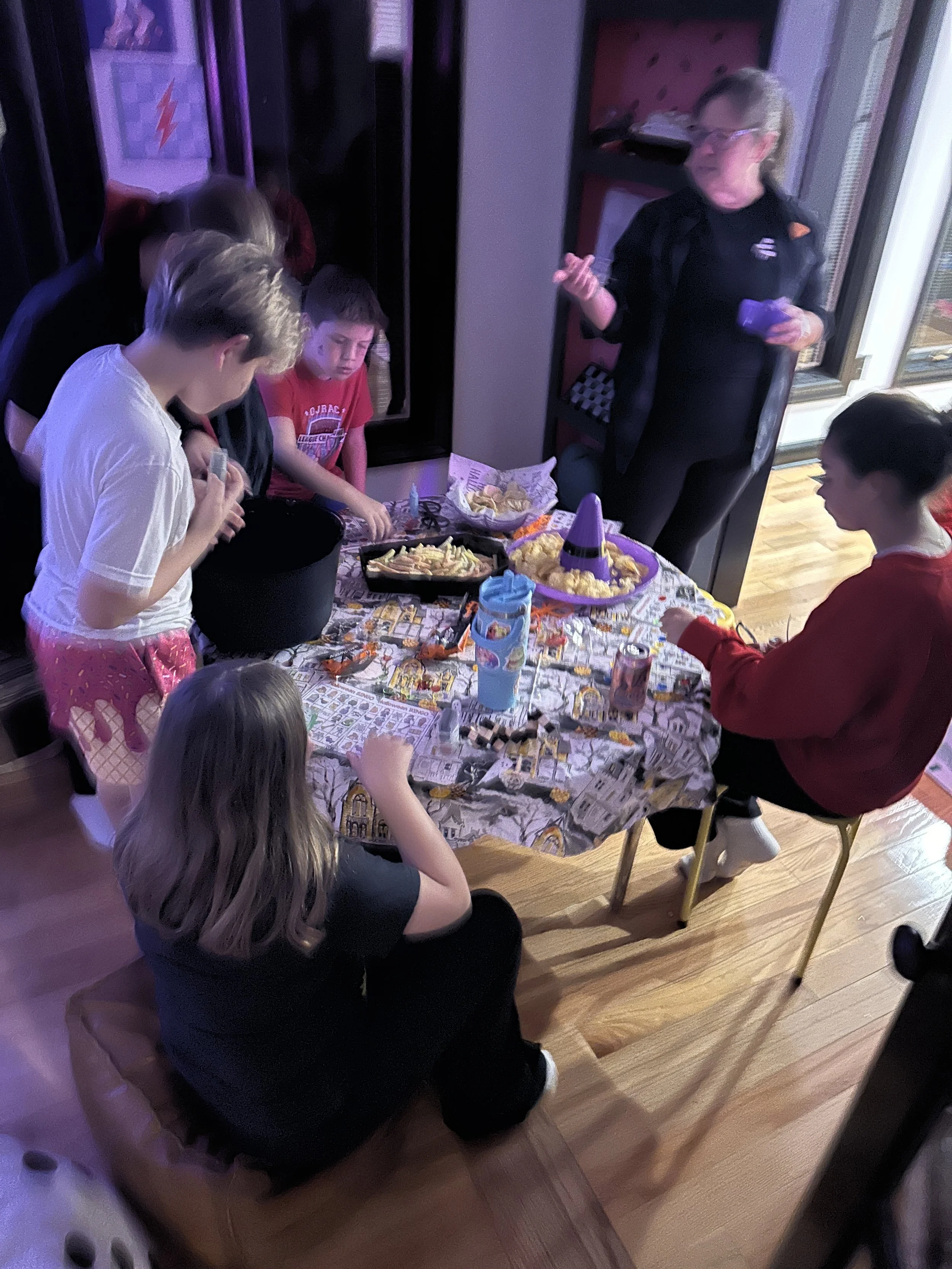 Tweens decorating reusable Halloween totes with puff paint at The Clubhouse Wellness Center in Phoenixville — hands-on art and self-expression through seasonal crafts.