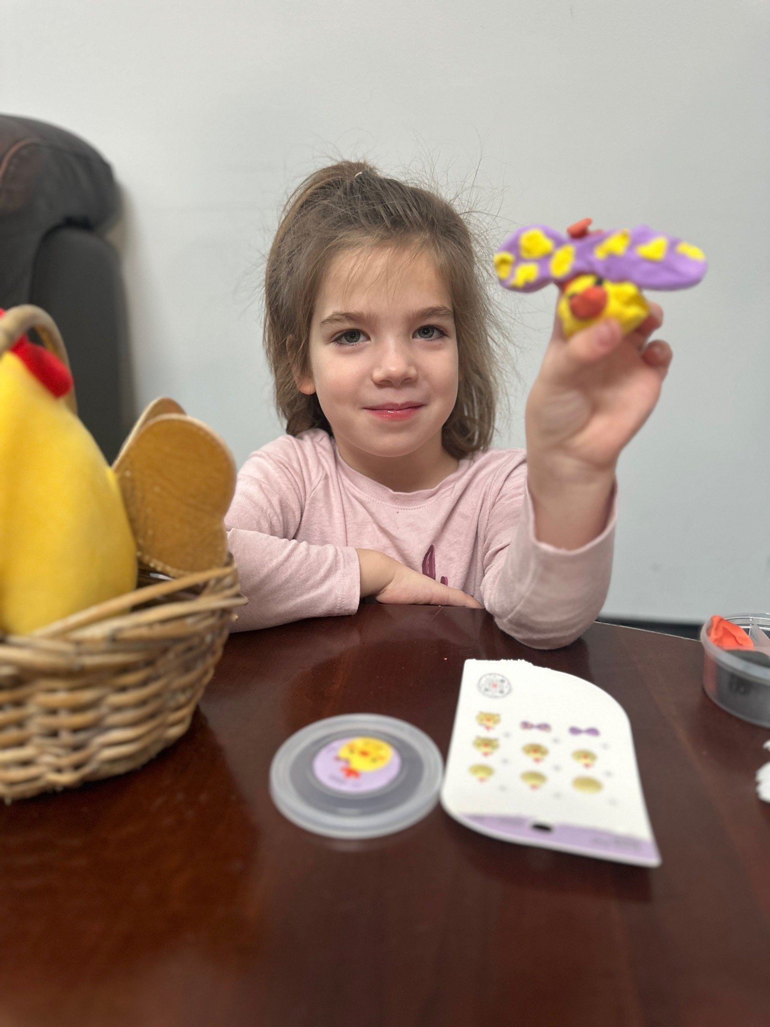 Girl showing butterfly craft at The Clubhouse kids art class in Phoenixville PA serving Main Line families