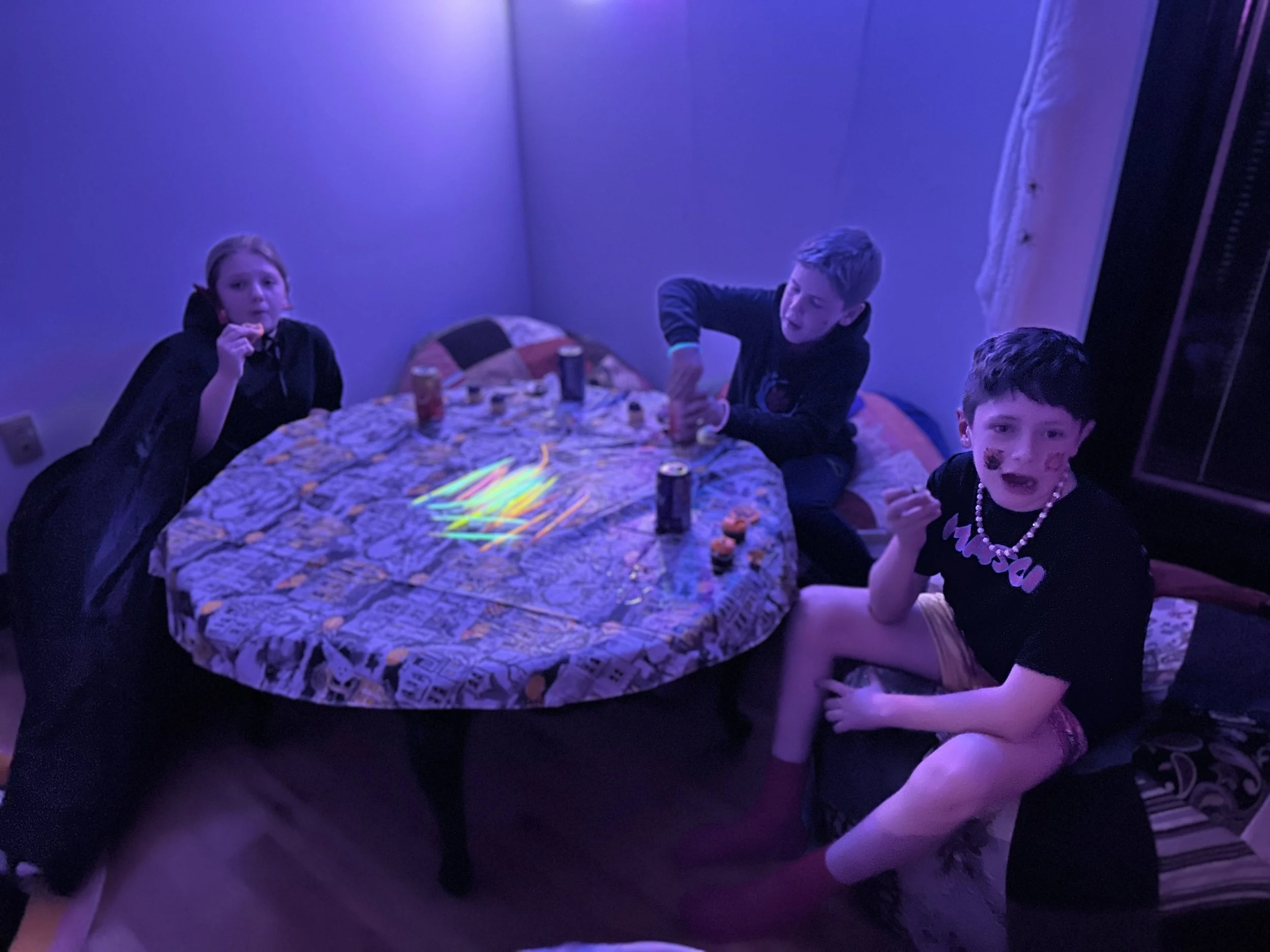 A group of tweens laughing and chatting around the craft table during The Clubhouse Wellness Center’s Tween Halloween Bash in Phoenixville, PA — creative fun and friendship in a safe, social setting.