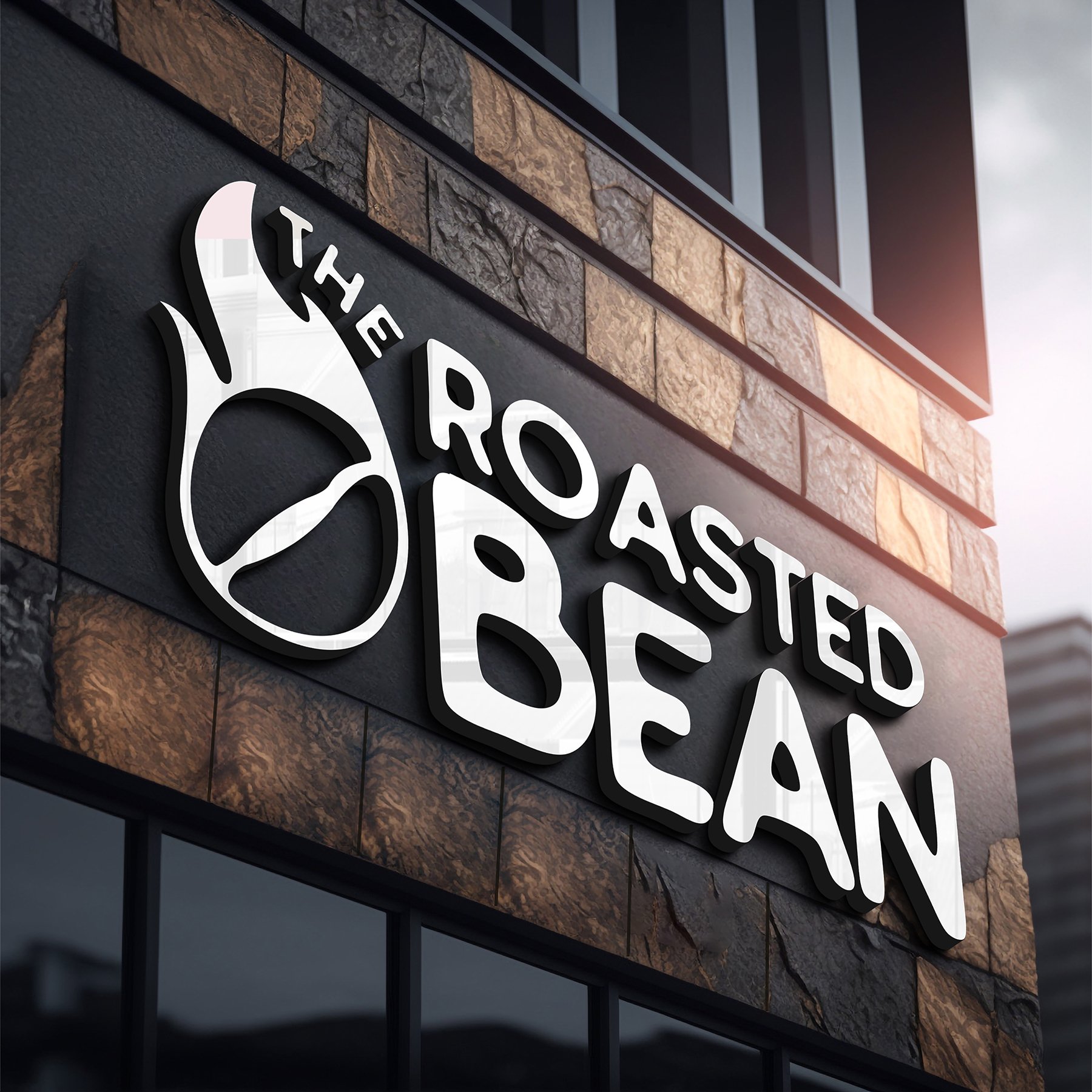 Exterior sign of "The Roasted Bean" coffee shop on a brick wall.