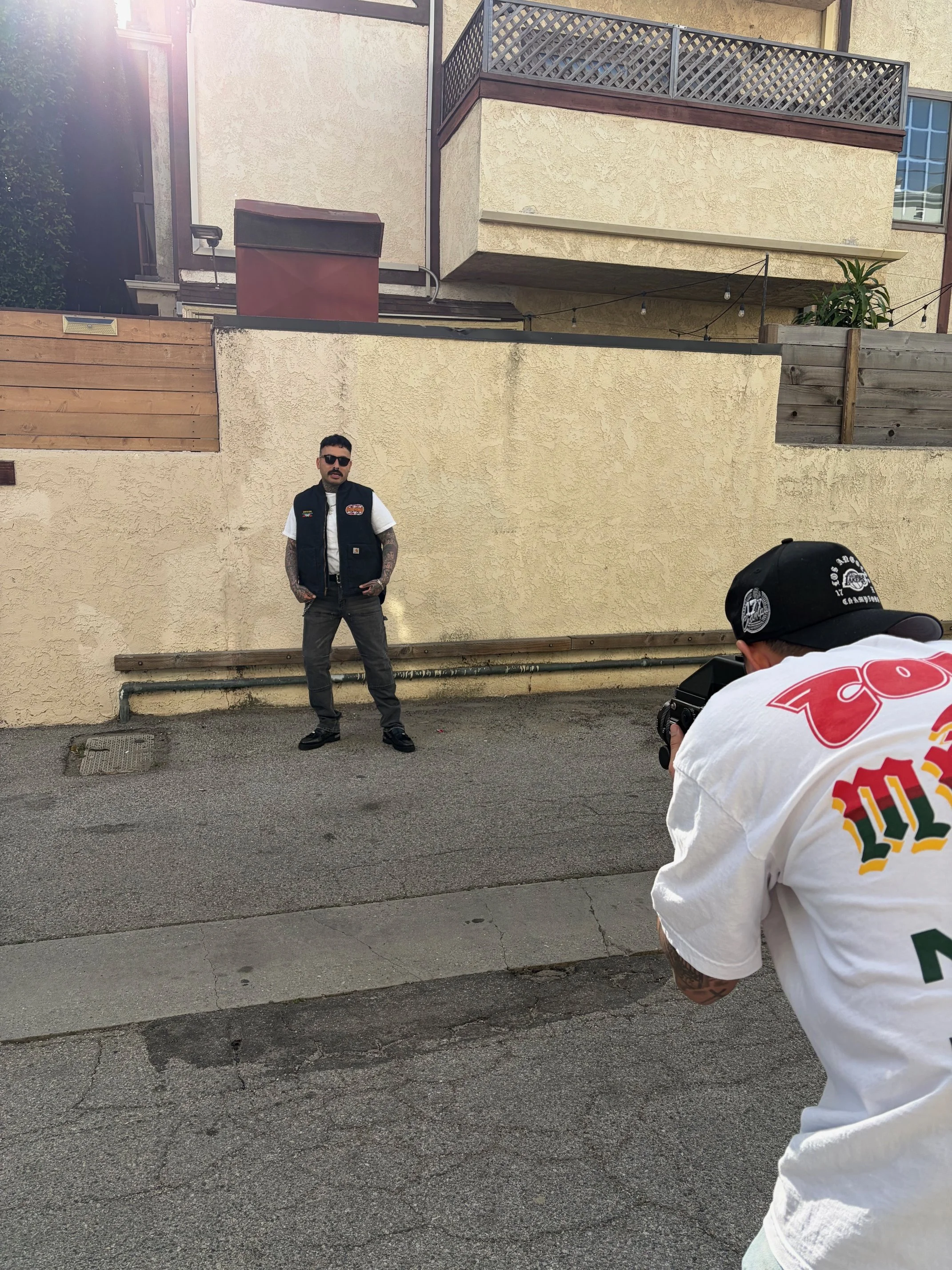 OG Streetwear GOD modeling a custom rock-n-roll themed vest. 