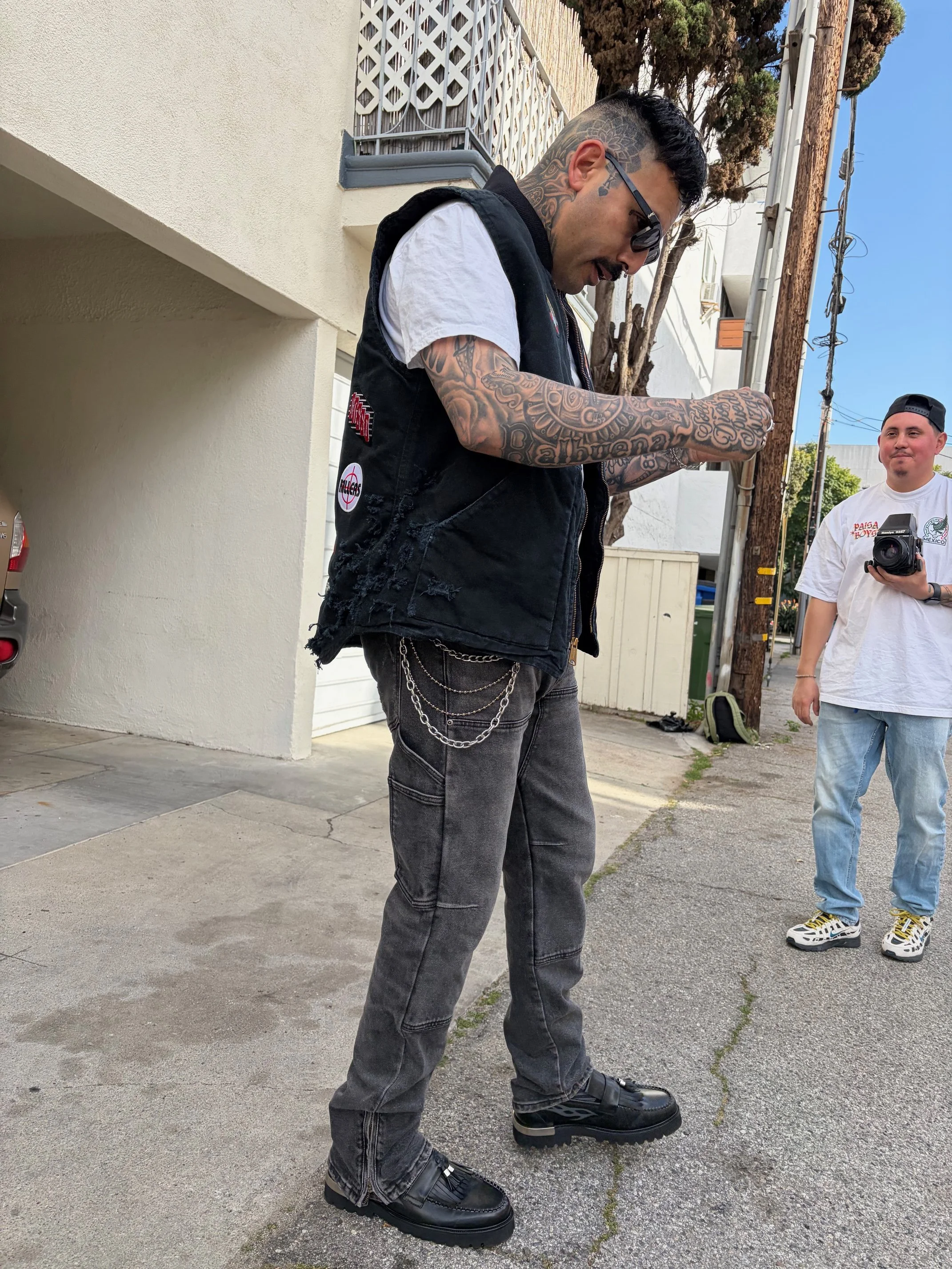 OG Streetwear GOD modeling a custom rock-n-roll themed vest. 