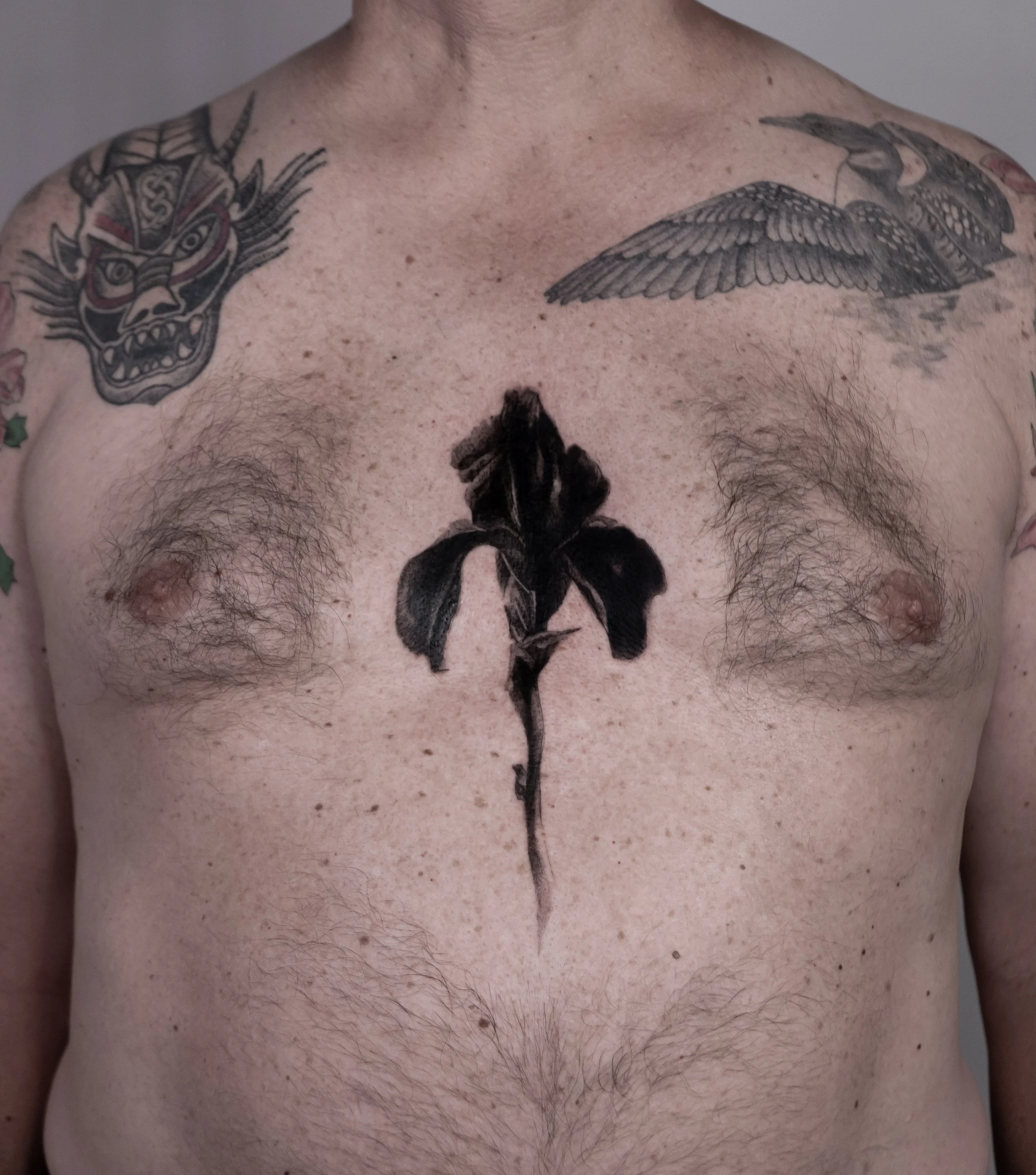 La fleur sombre - from my catalogue. 
Find more through link in bio ⛓️
Booking now: September and October in Washington DC &amp; San Francisco.
Wait list: Boston, NYC, LA

#surrealismtattoo #darkfloraltattoo #darkaesthetic #iristattoo