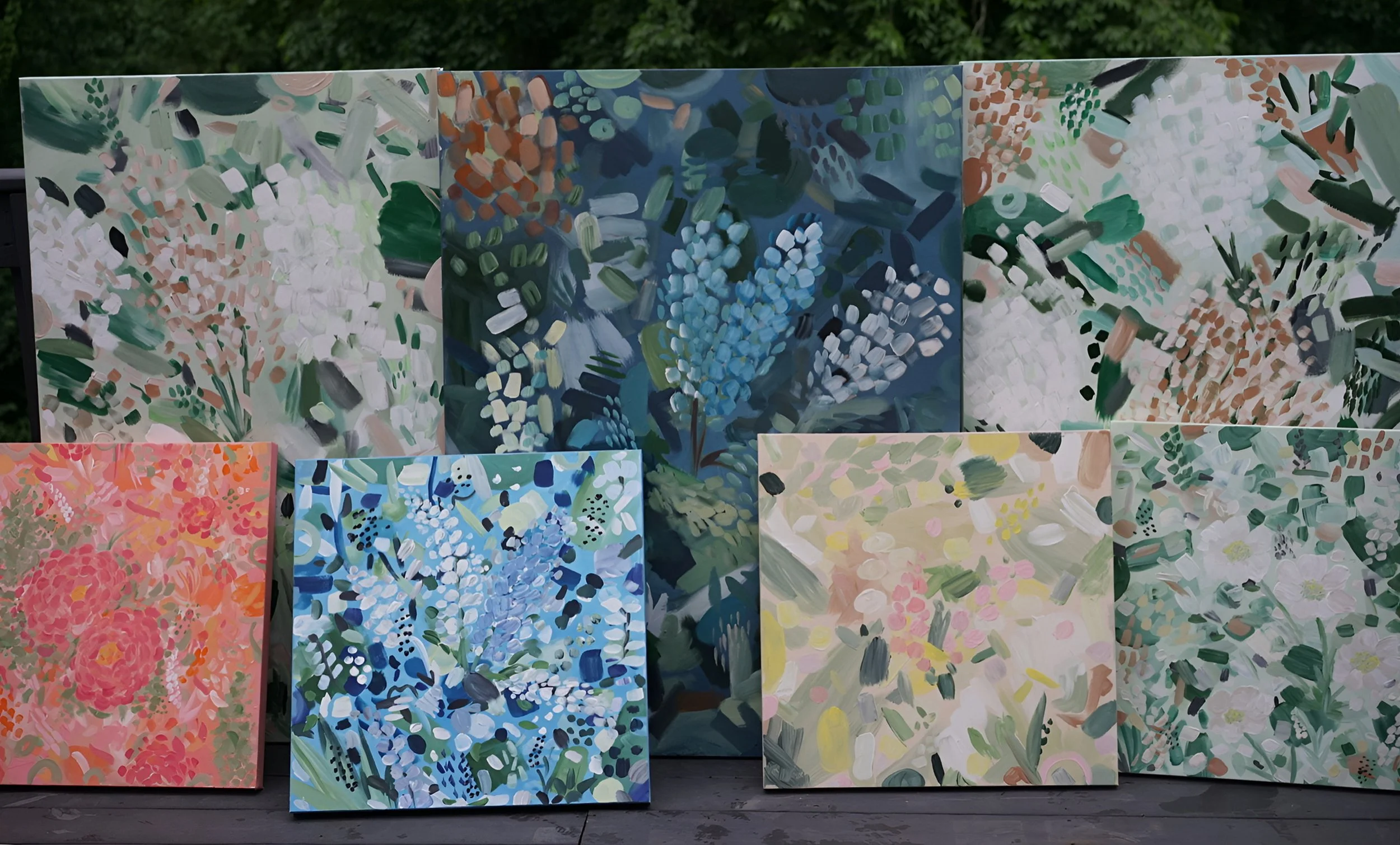 Collection of seven colorful abstract floral paintings, featuring various shades of green, blue, pink, peach, and cream with impressionistic brushstrokes.