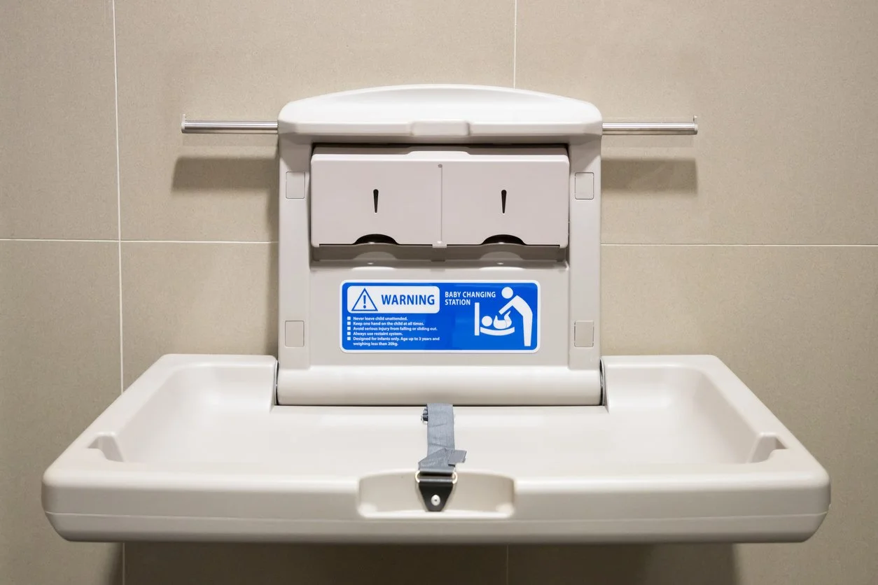 Diaper changing table in a public restroom.
