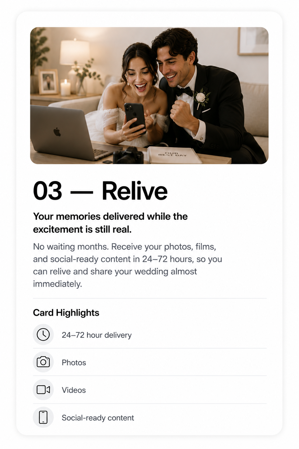 Couple in wedding attire sitting on a couch, looking at a phone, with a laptop and wedding planning materials on the table in front of them, in a cozy, well-lit living room.