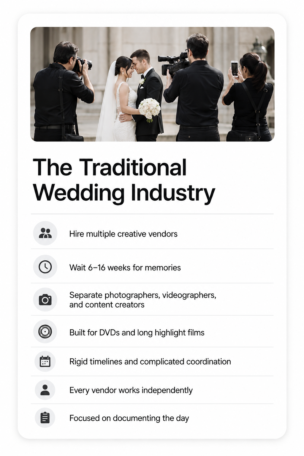 A wedding photo showing a bride and groom embracing, surrounded by photographers and videographers taking pictures and videos, on the steps of a building with columns.