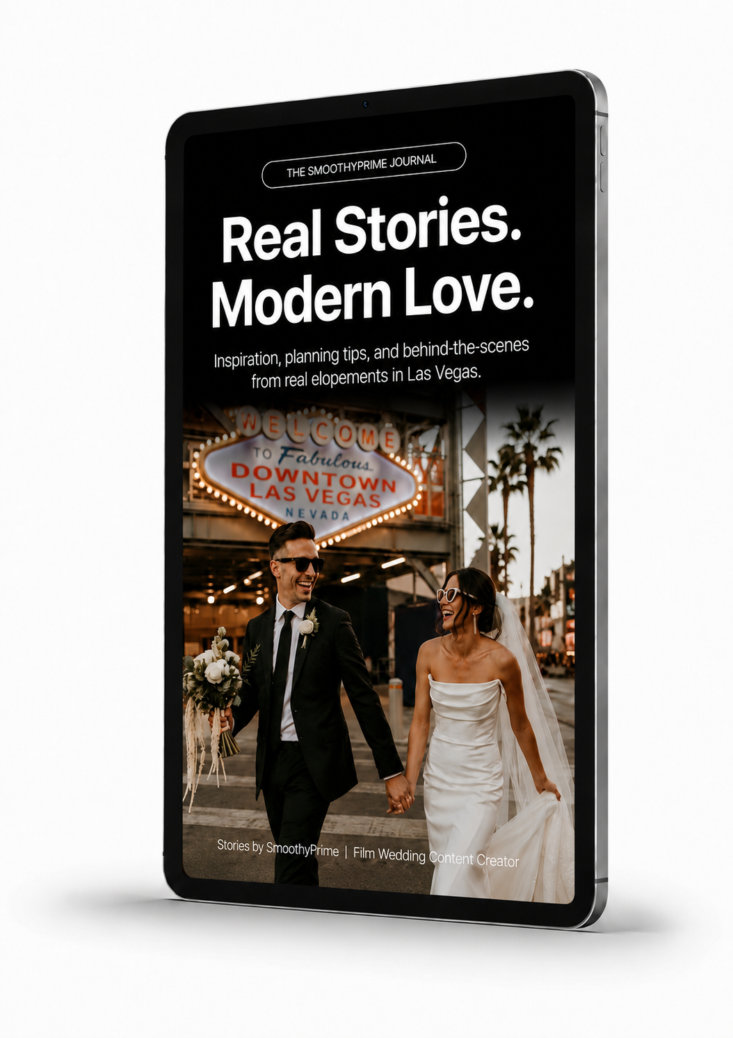 A digital tablet displaying a magazine cover featuring a couple in wedding attire holding hands, walking in front of a neon "Welcome to Fabulous Downtown Las Vegas" sign, with palm trees and the cityscape in the background.