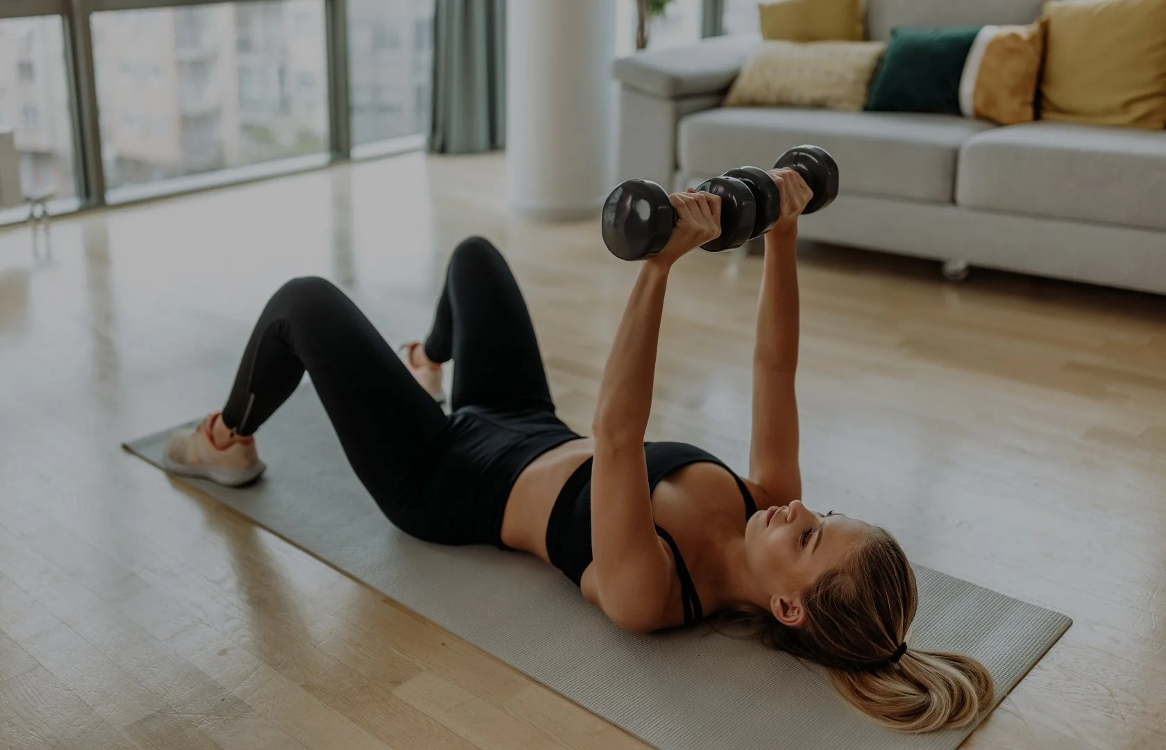 Woman strength training with dumbbells for health and longevity