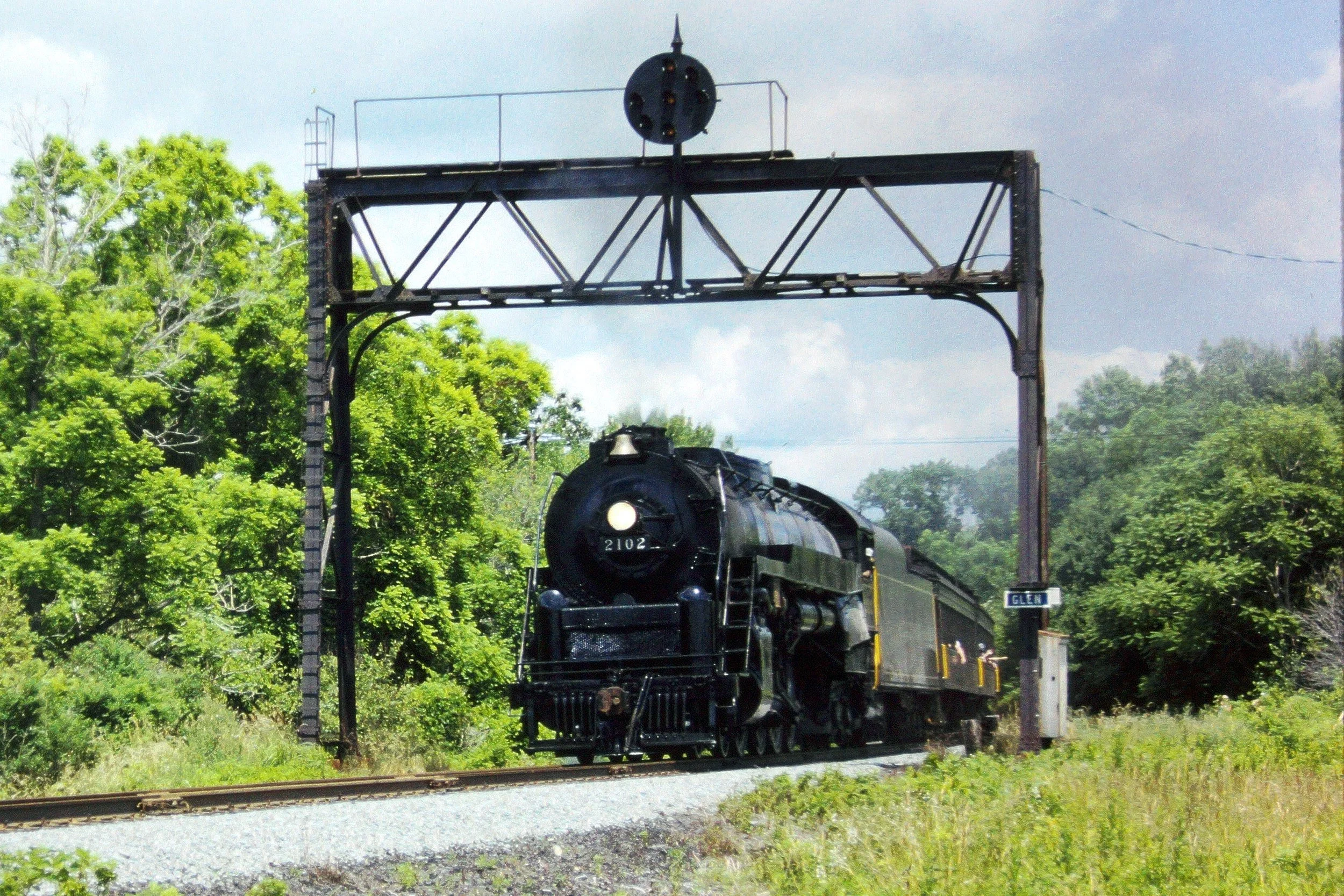 During the Blue Mountain & Reading Railroad's 1987 Railfan Weekend, Reading No. 2102 thunders beneath the ex-Pennsylvania Railroad position light signal at Glen Junction. Greg Brown photo.