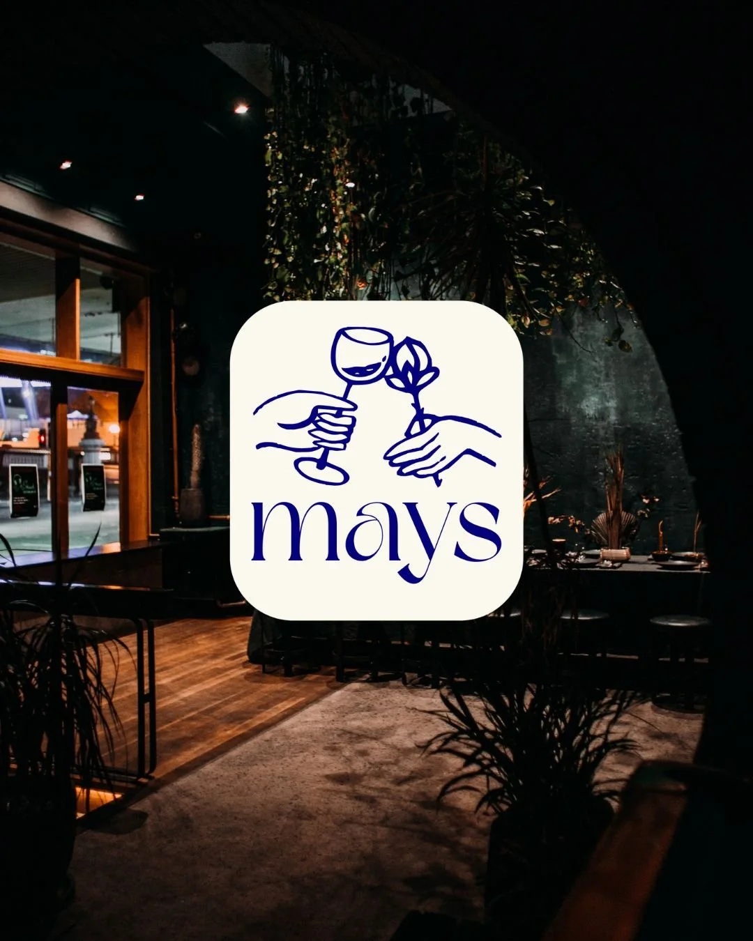 Logo of Mays featuring a line drawing of a hand holding a glass of wine and another hand holding a flower, with the word 'mays' written below.