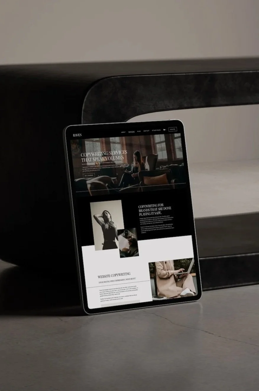 Tablet displaying a website about copywriting services, with images of people working and text about website copywriting, placed on a concrete surface near a dark table.