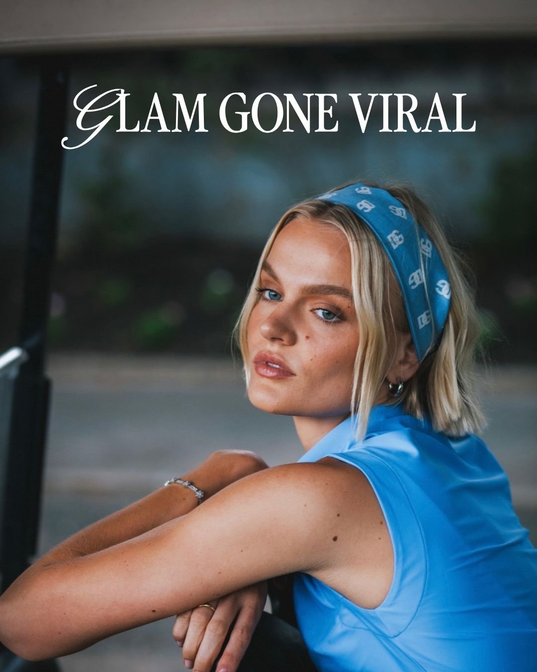 A young woman with blonde hair wearing a blue headband and blue sleeveless top, sitting and looking at the camera with a serious expression. The text 'Glam Gone Viral' is at the top of the image.