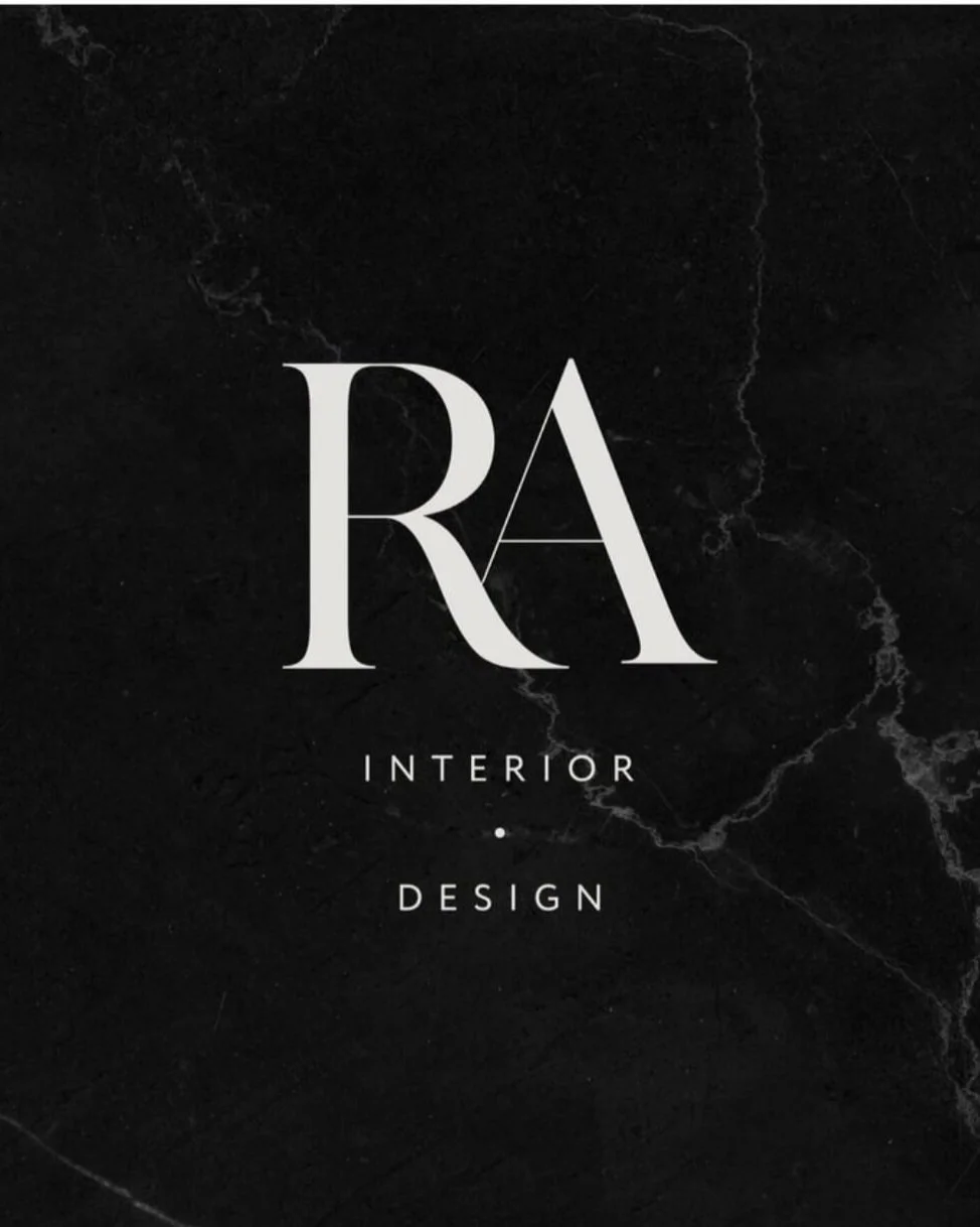 Black marble background with white text that reads 'RA Interior Design'.