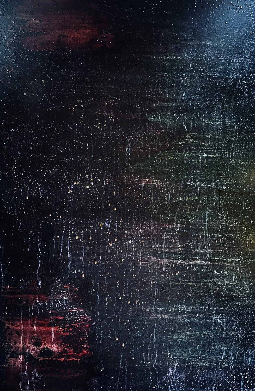 Abstract dark textured background with scattered small colored specks and streaks.