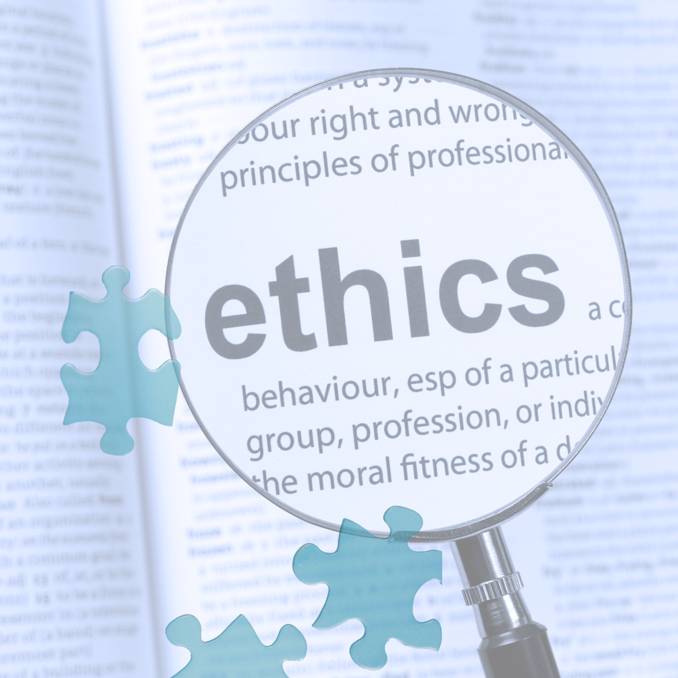 Magnifying glass focused on the word 'ethics' in a dictionary, surrounded by puzzle pieces.