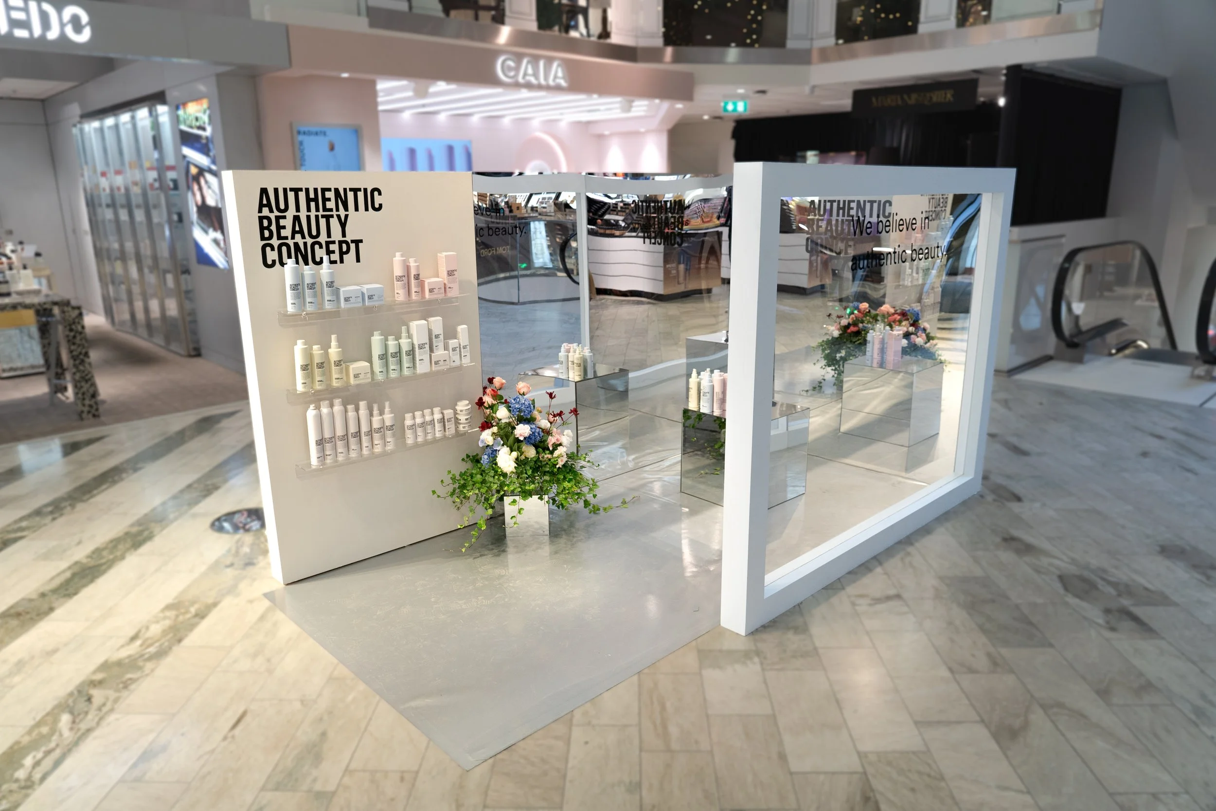 An expo pop-up for a hair brand in white.