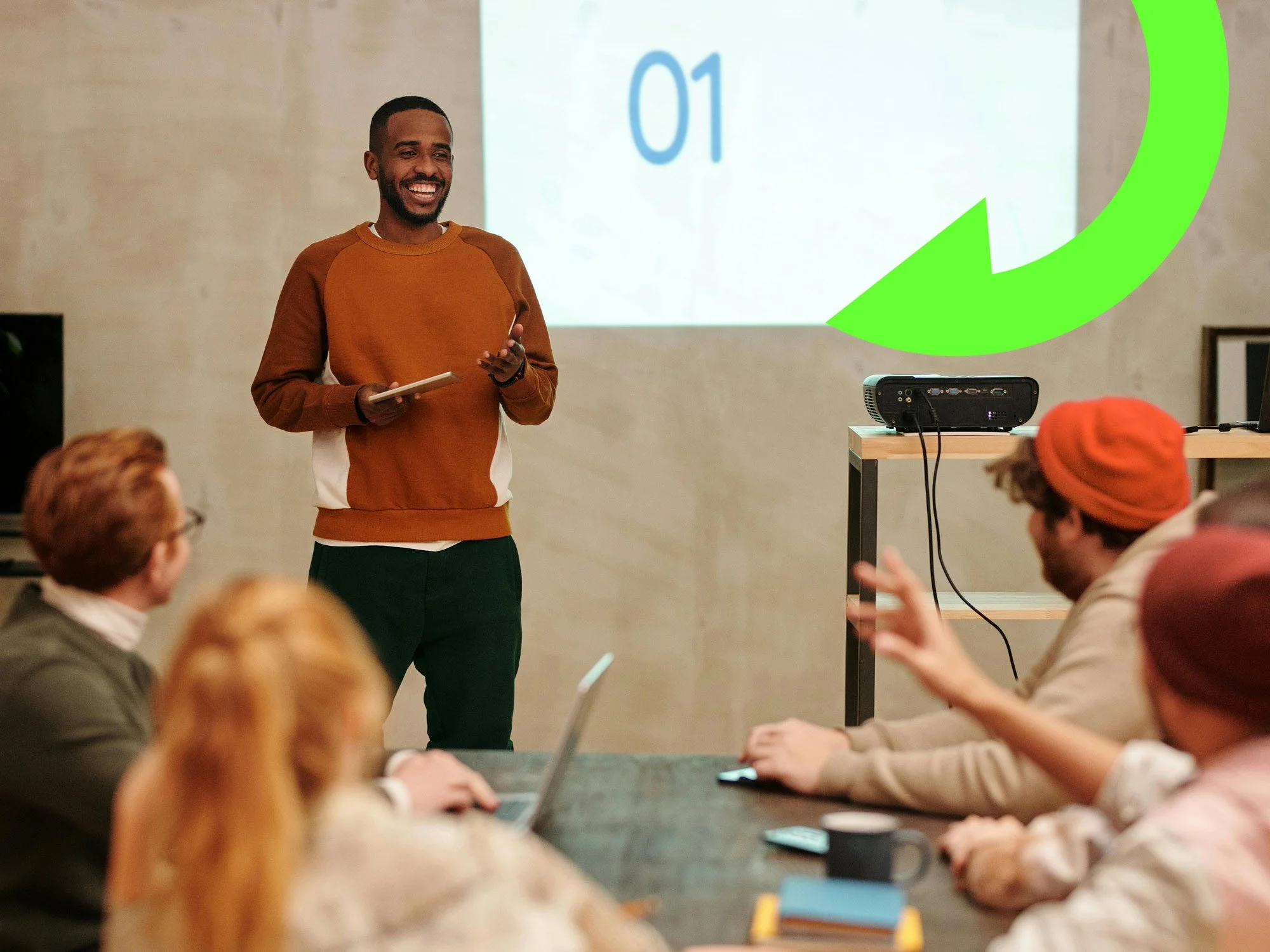 One man presenting to a table of people.