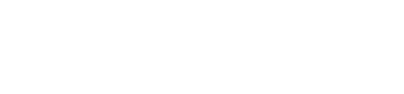 A mountain landscape with snow-covered peaks, lush green trees, and a clear blue sky.