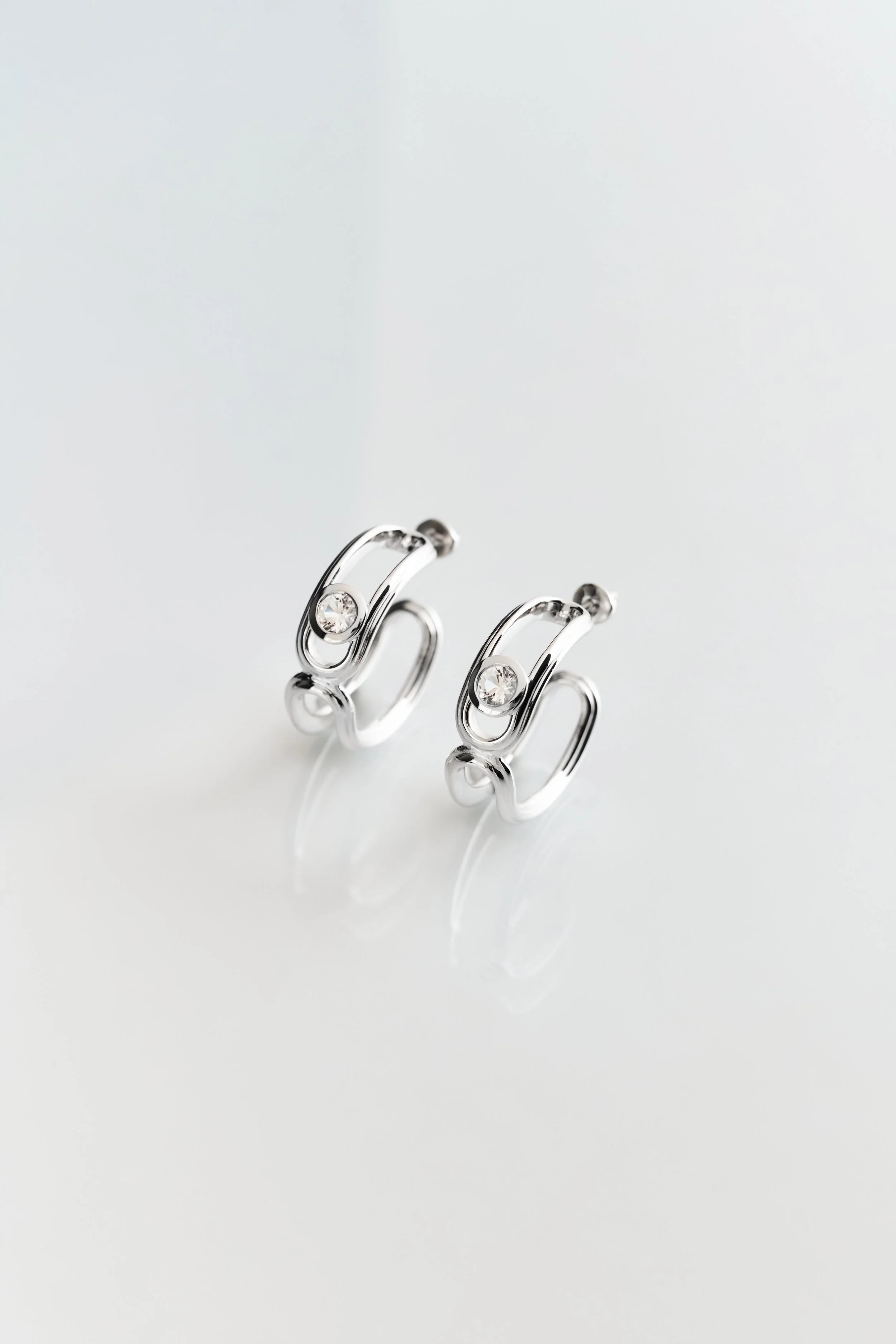 Hollow Hoop Earrings by Lottie’s Loft, crafted in rhodium vermeil sterling silver with white topaz — elegant sculptural jewellery for everyday wear.