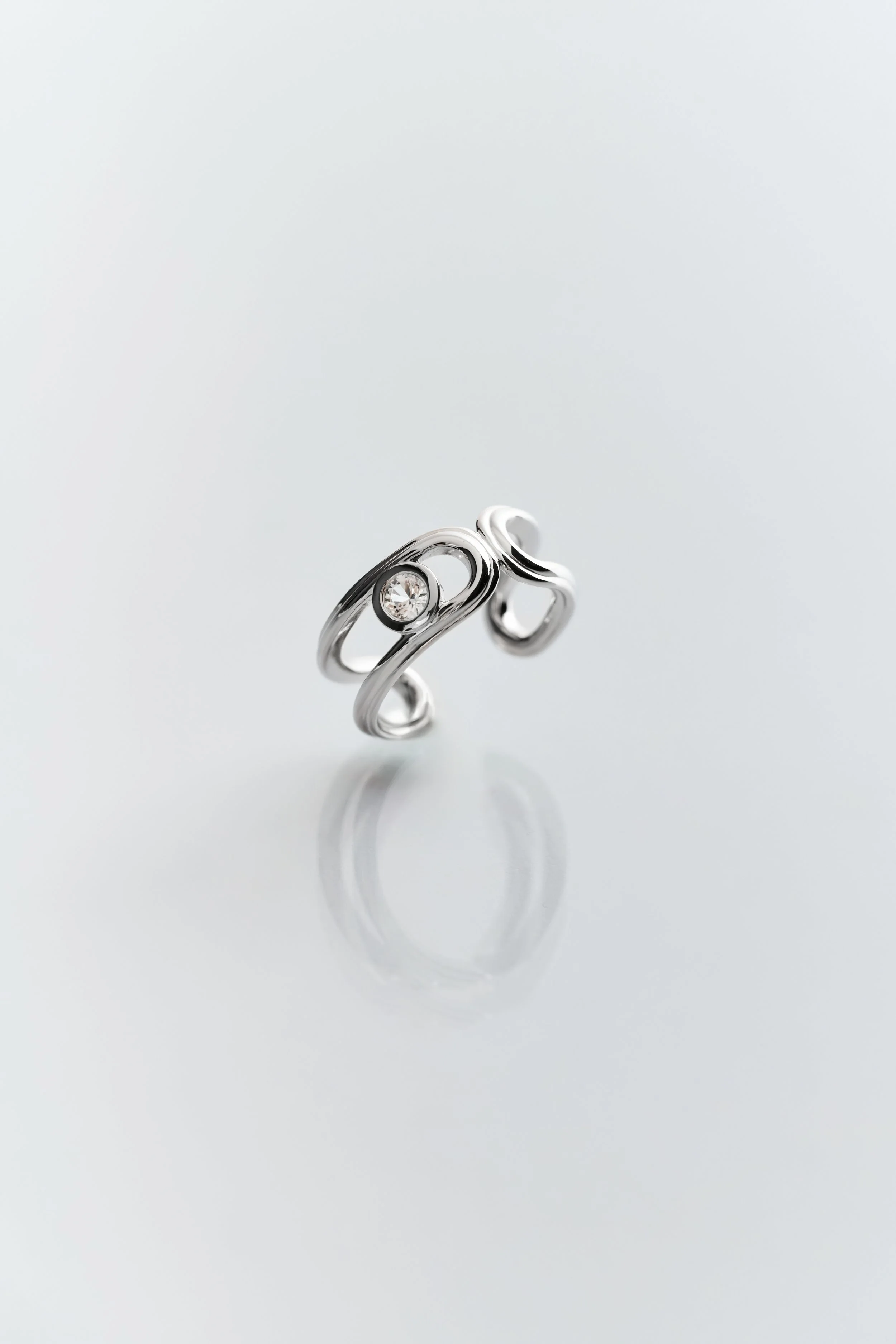 Sculptural and refined: Hollow Hoop Ring by Lottie’s Loft, crafted in rhodium vermeil sterling silver with white topaz.