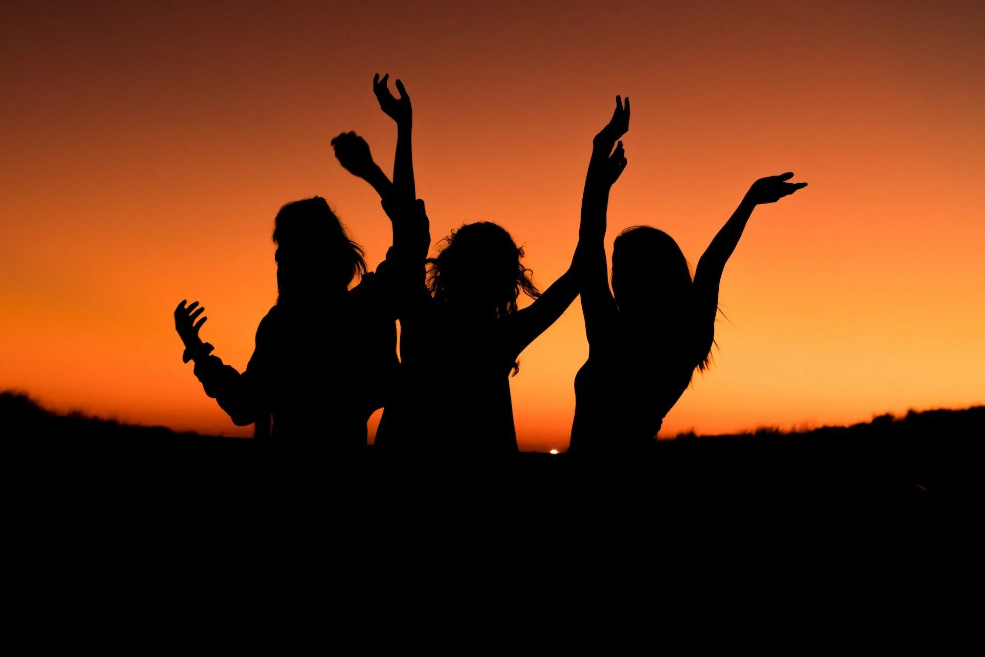 three women silhouette in the sunset