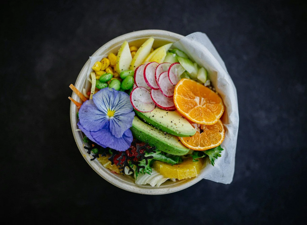 bowl of healthy food, orange, avocado, corn, edemame,