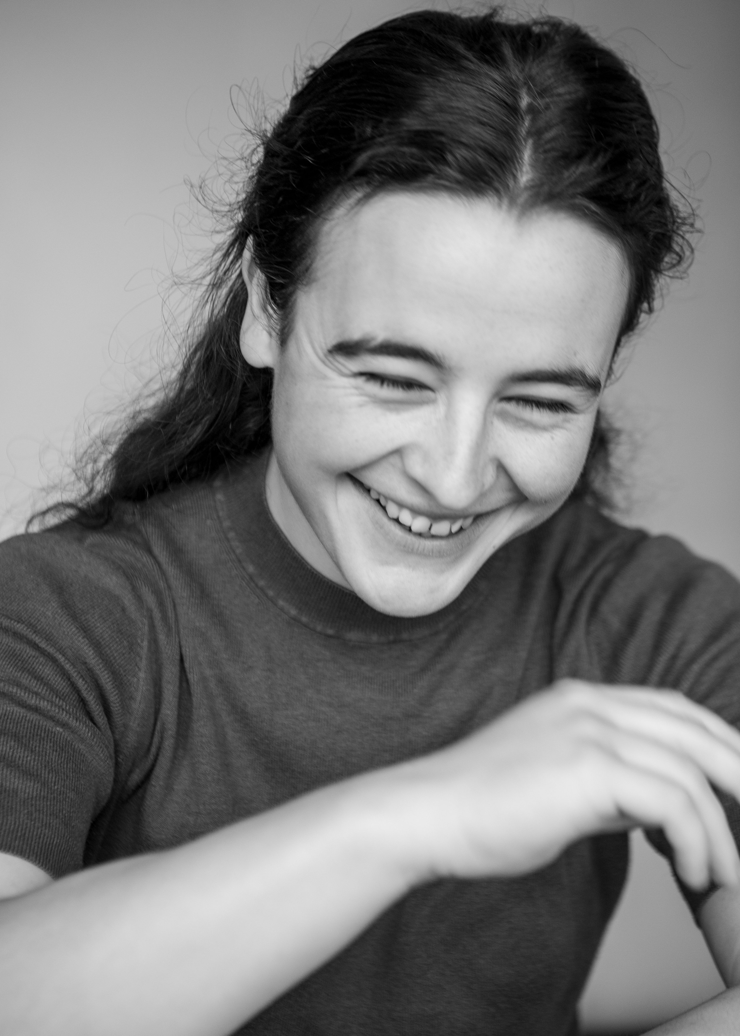 Black and white photo of a person laughing