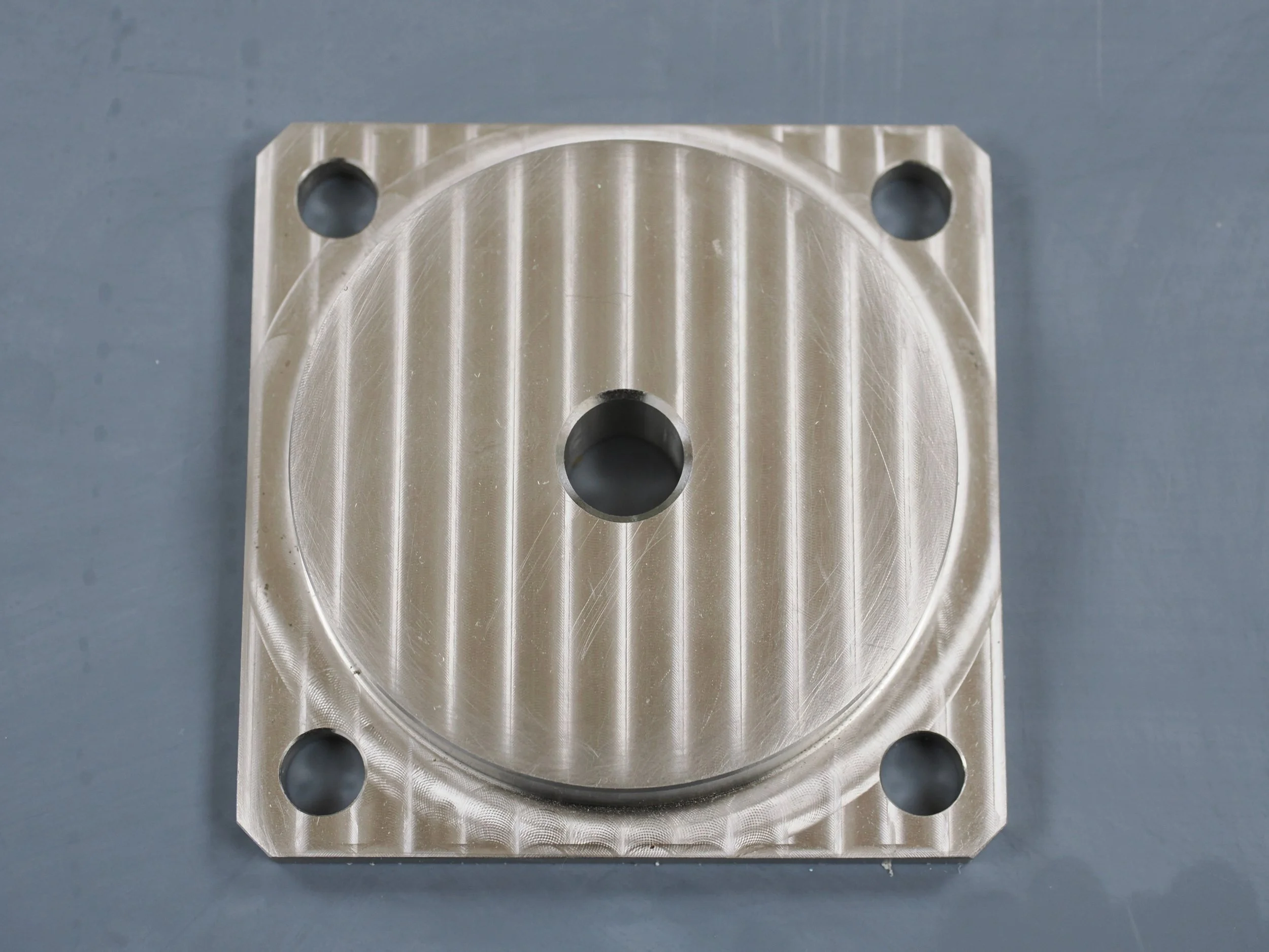 Metal machined part with drilled holes.