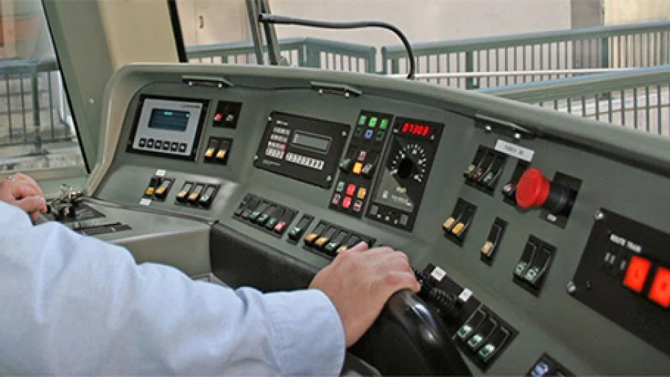 Train operator runs the train at the control panel.