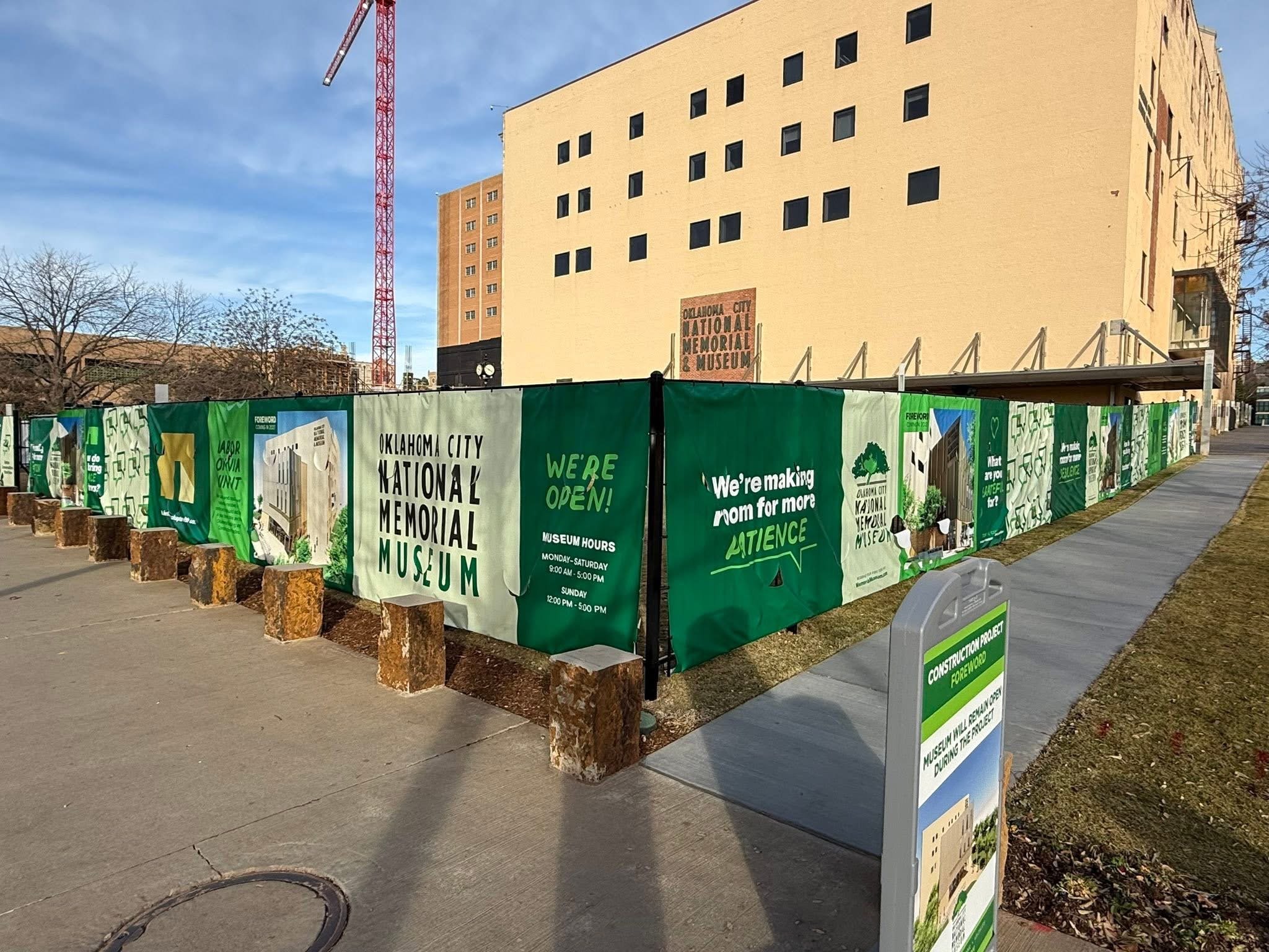 Construction fencing now frames a significant portion of the Museum’s entrance, creating an unexpected opportunity for both storytelling and wayfinding. Through thoughtful graphics and messaging, the fence clearly signals how to access the Museum whi