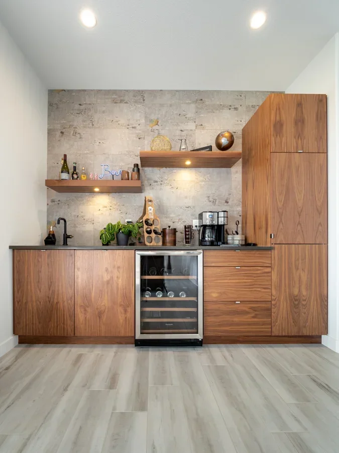 Naturally stained wood veneer bar with wine fridge and floating shelves